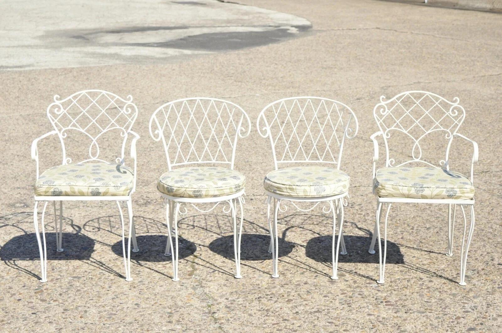 Vintage French Victorian Style White Wrought Iron Lattice Garden Patio Dining Set - 5 Pc Set. Listing includes rectangular glass top dining table, (2) armchairs, (2) side chairs, lattice design backs, wrought iron construction. Slightly different