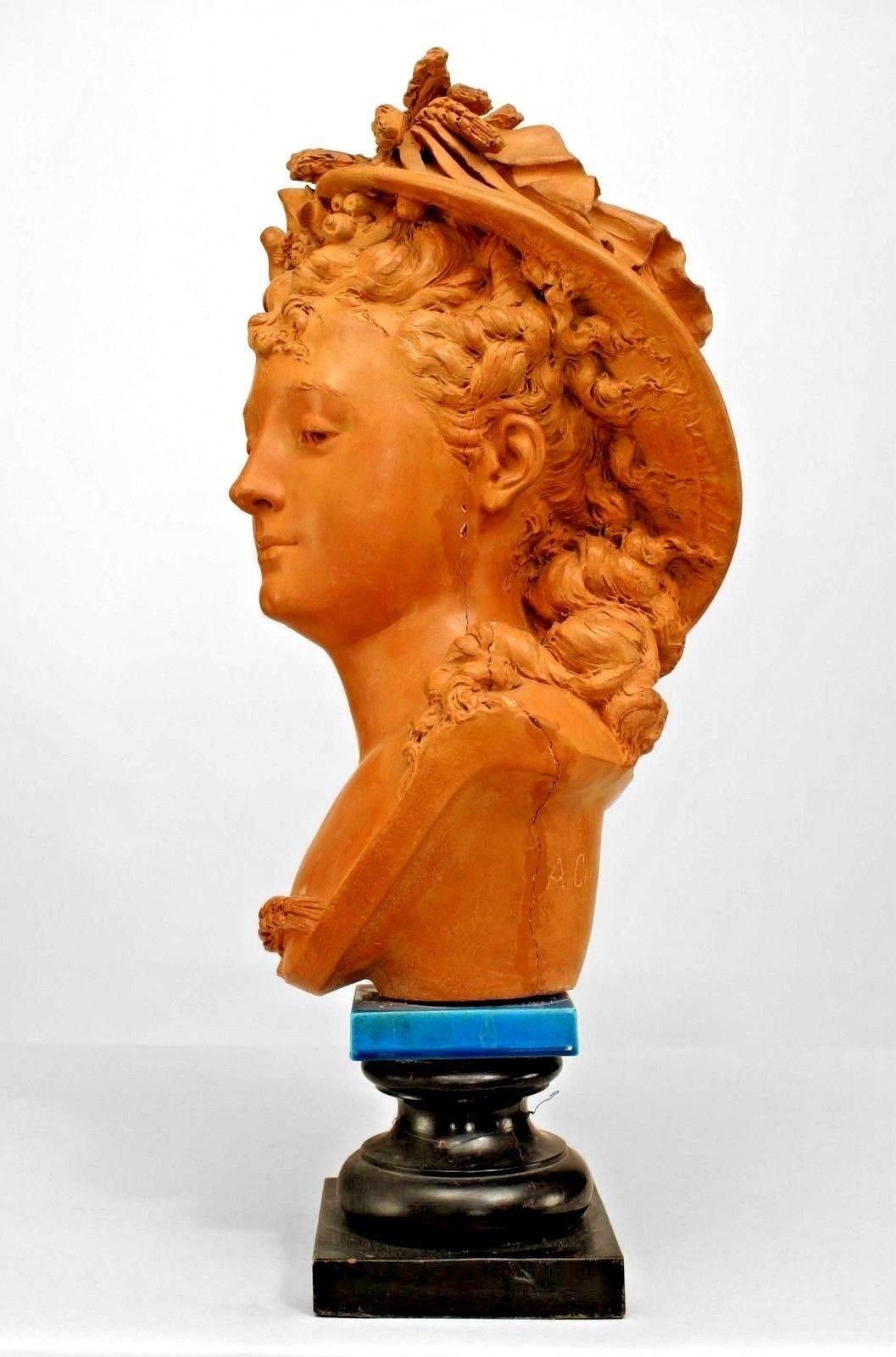 French Victorian terra cotta bust of 19th Century lady wearing a hat and flowers in hair on blue porcelain & black painted square base (signed CARRIER BELLEUSE) (AS IS)
