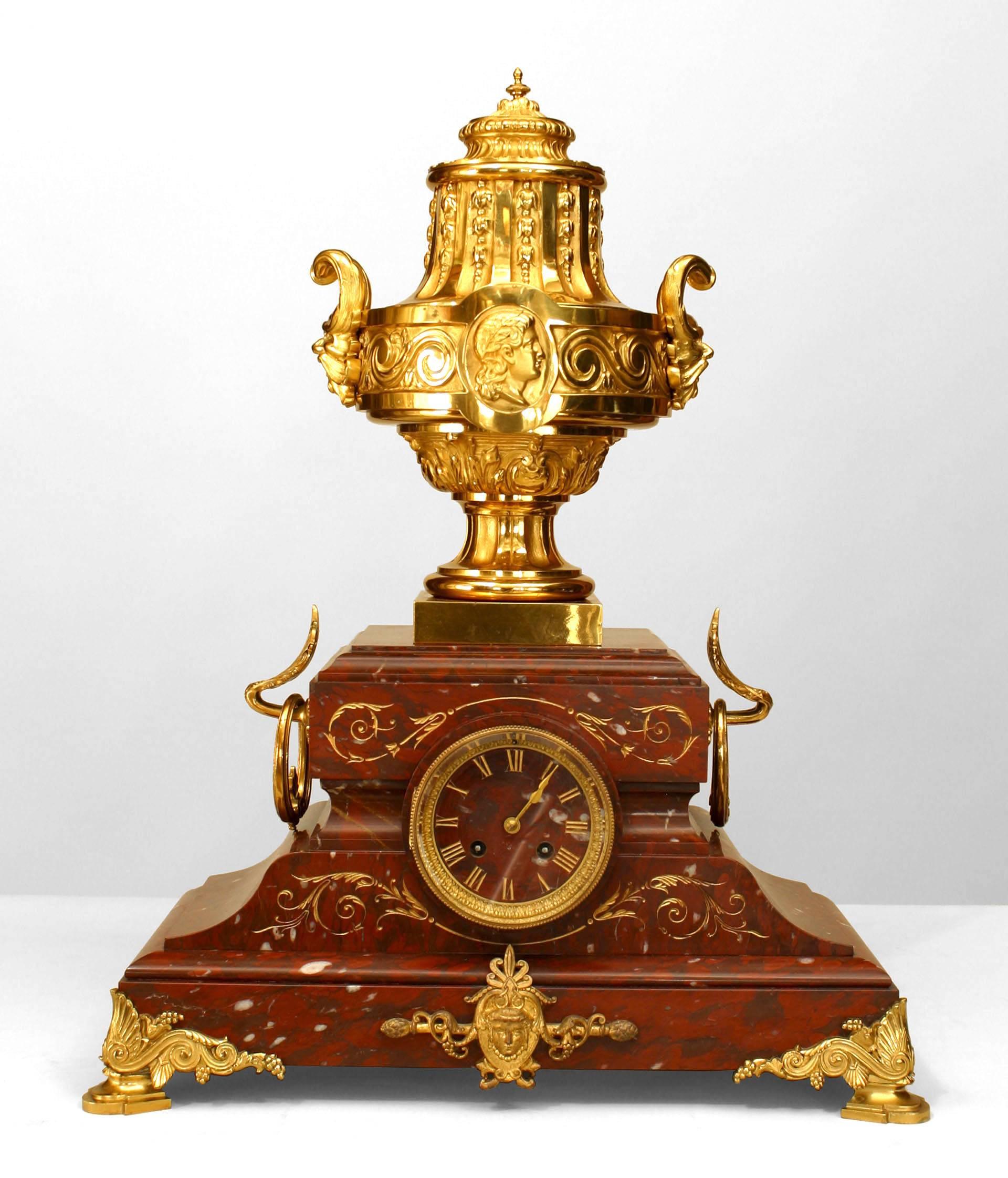 3-Piece French Victorian rouge marble clock set with a clock trimmed in gilt bronze supporting an urn and a Pair of 6 arm candelabra with a gilt bronze urn (10