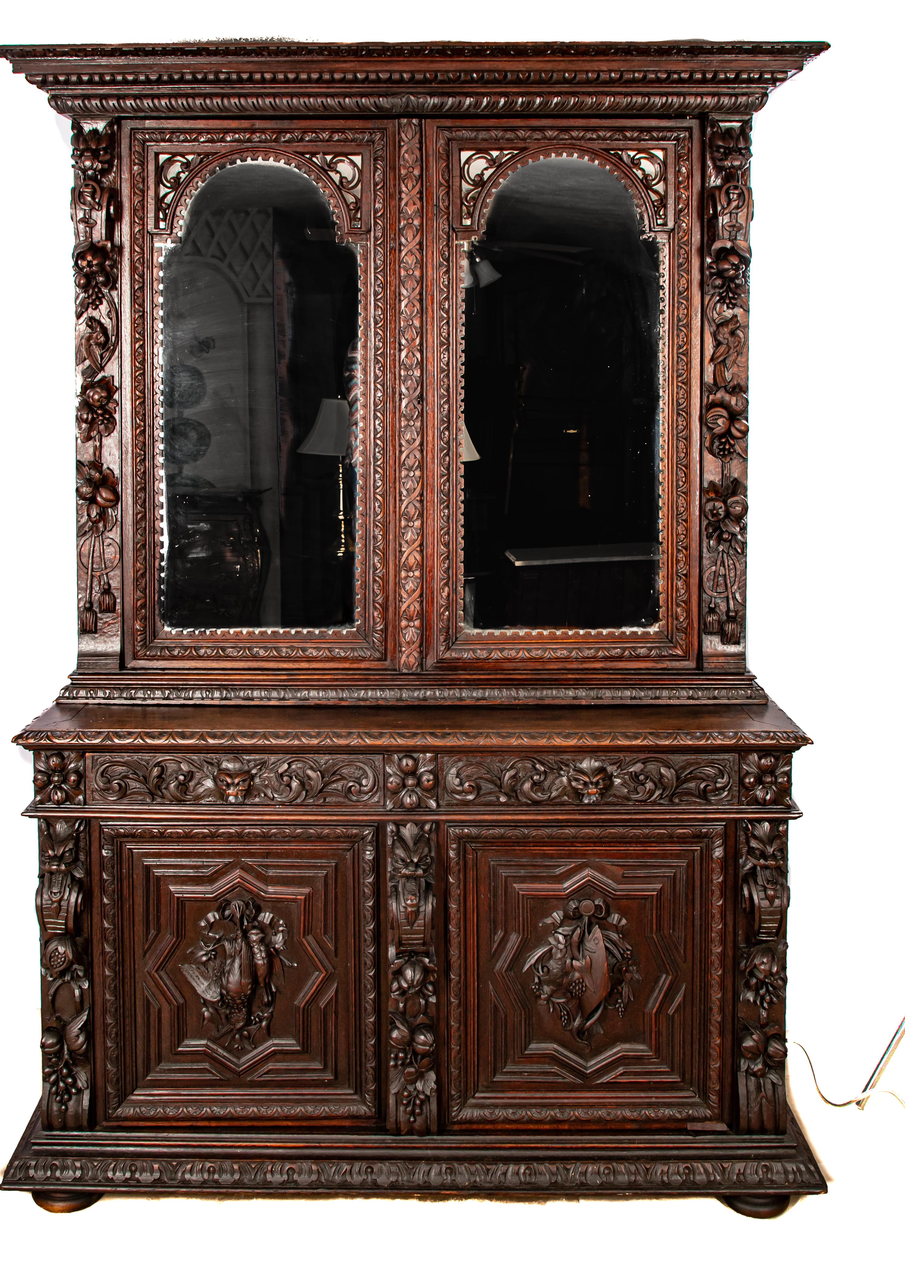 Offering this magnificent French Victorian cupboard. Starting on a massive base the two doors on the bottom have carving. One has a pheasant and the other a fish with fruits and vegetables around them. Rising from there it has two drawers each