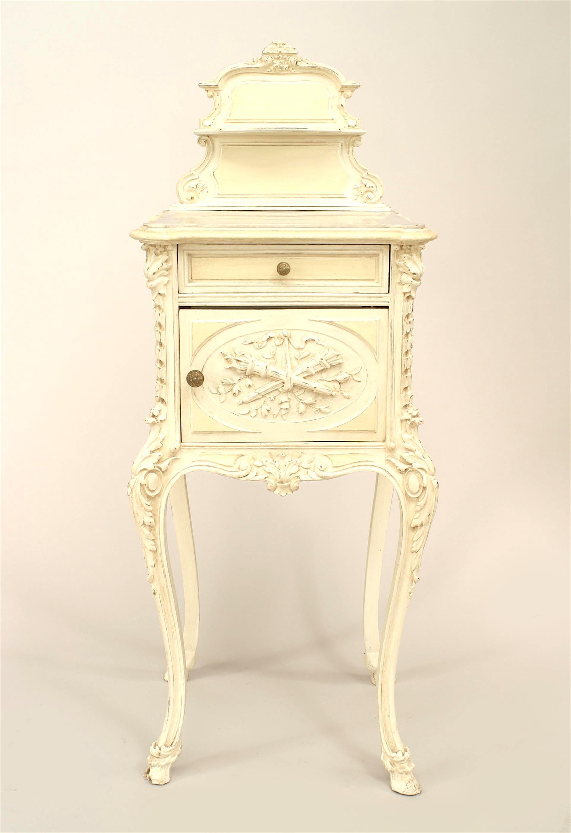 French Victorian white painted and carved bedside commode with inset marble top and a shaped back rail.
