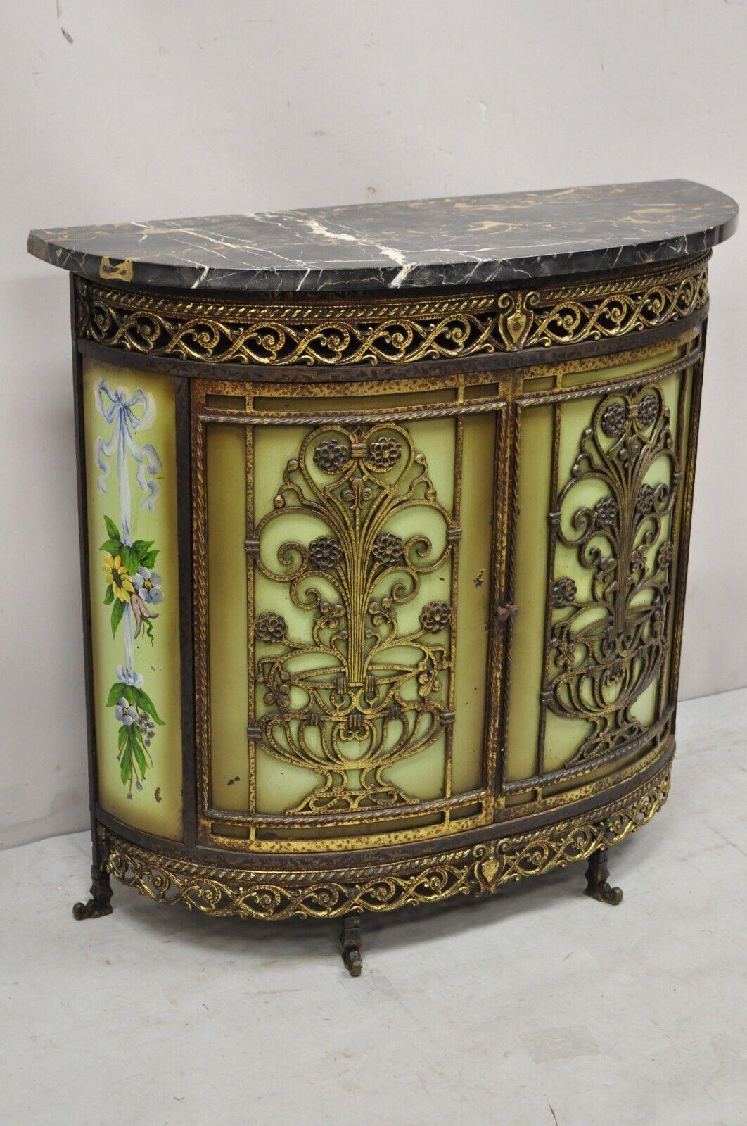 French Victorian wrought iron Oscar bach Demilune marble top console cabinet. Item features a hand painted green finish with flower, demilune marble top, pierced iron details, wrought iron construction, 2 swing doors, very nice antique item, great
