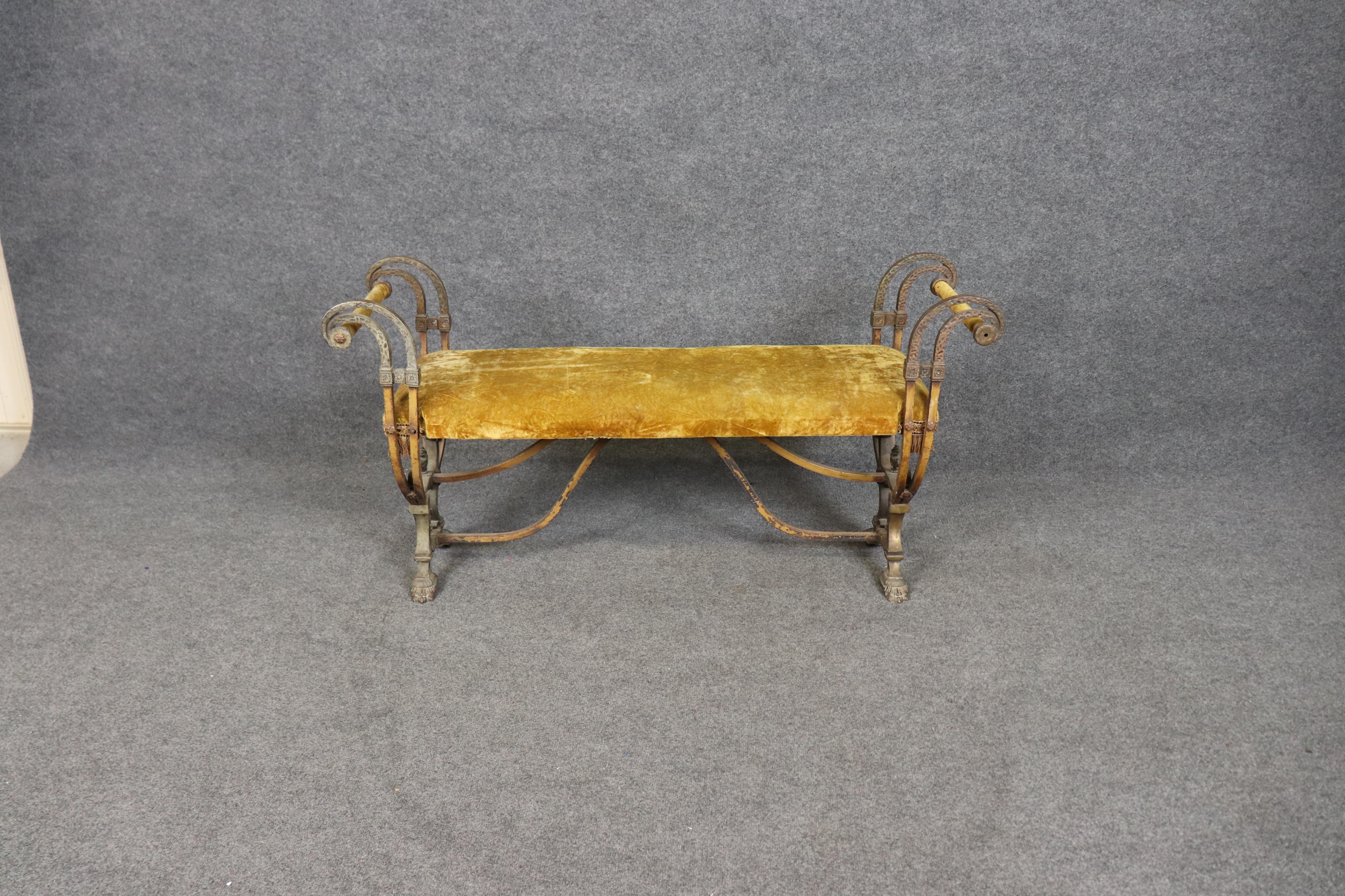 This French Victorian era wrought iron bench is a striking example of 19th-century craftsmanship, combining elegance, durability, and timeless style. The hand-forged iron frame features beautifully scrolled arms, intricate decorative detailing, and