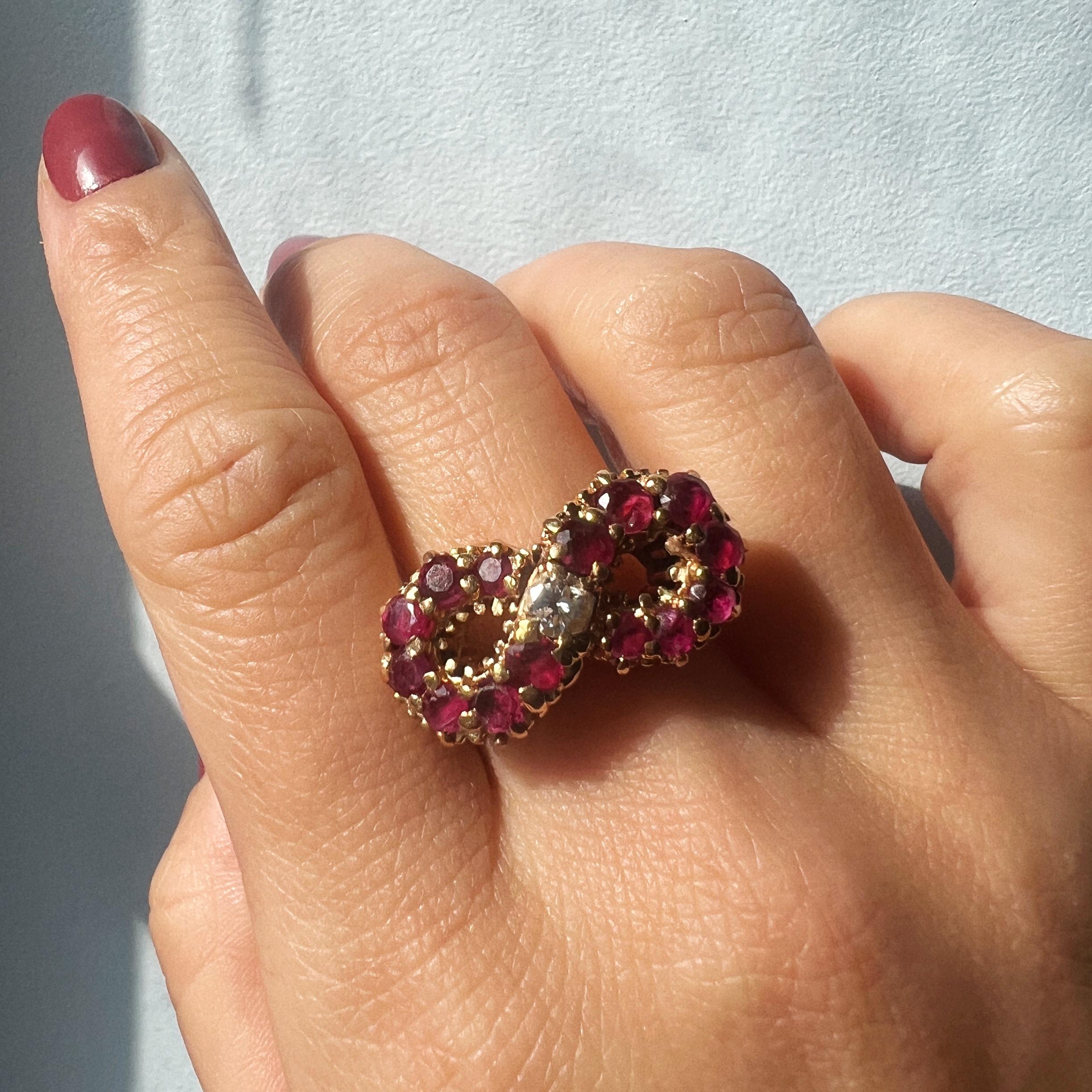 For sale a stunning solid 18K gold retro cocktail ring, featuring a unique intersect design which resembles the number 8, also the symbol of eternity. The design is adorned with 14 vibrant purplish-red rubies with an estimated weight of 1.2ct, as