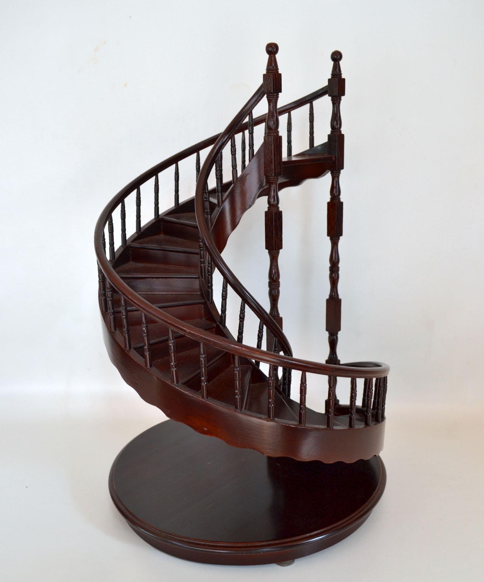 French 20th century model of a spiral staircase of late 18th century design, with fifteen steps, double turned balusters on a circular plinth base made of mahogany in superb quality. This wooden piece of architecture, completely handmade. It is