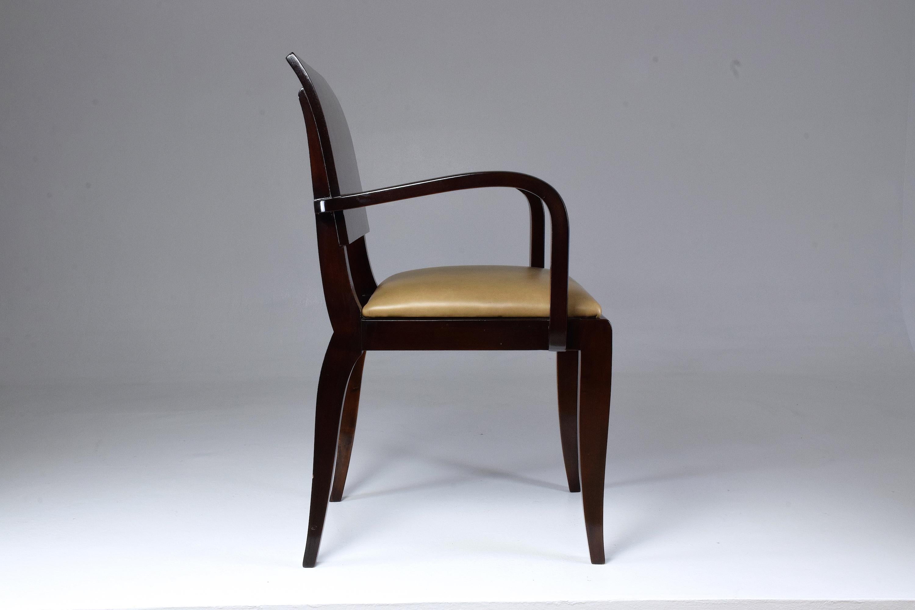20th-century vintage French armchair or office chair in restored condition composed of curved armrests and a leather seat in Art Deco style.
France, circa 1940s.