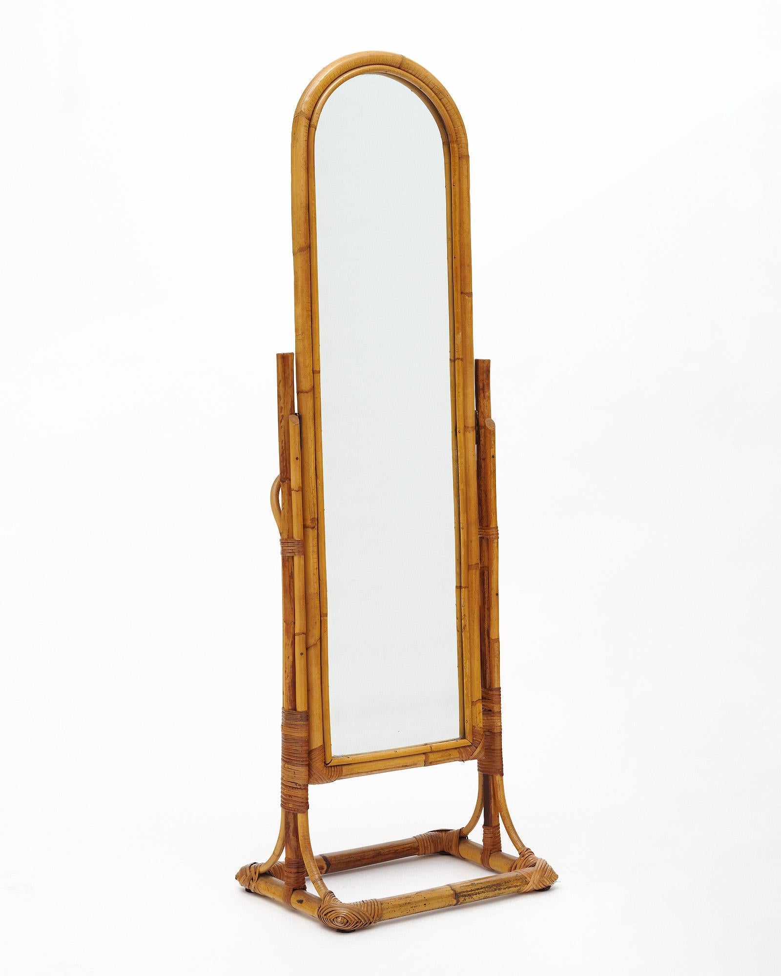 Psyche Cheval bamboo mirror from France. This charming mid-century piece features its original mirror in a frame pivoting within a bent bamboo structure on feet.
