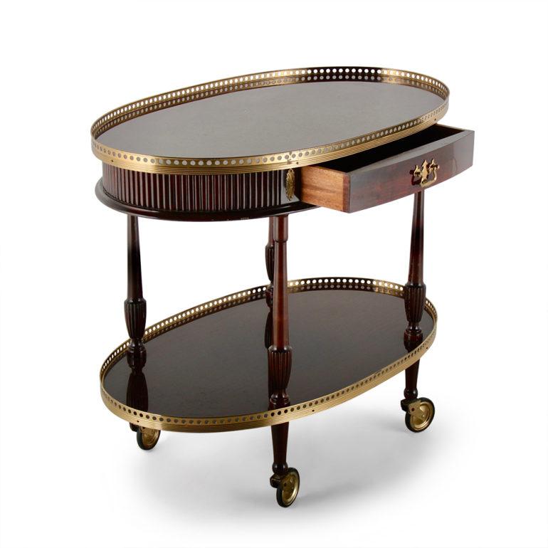 Elegant bar cart with beautiful brass trim, a second shelf, and a lovely pierced gallery. One of a kind, circa 1950.
 
  