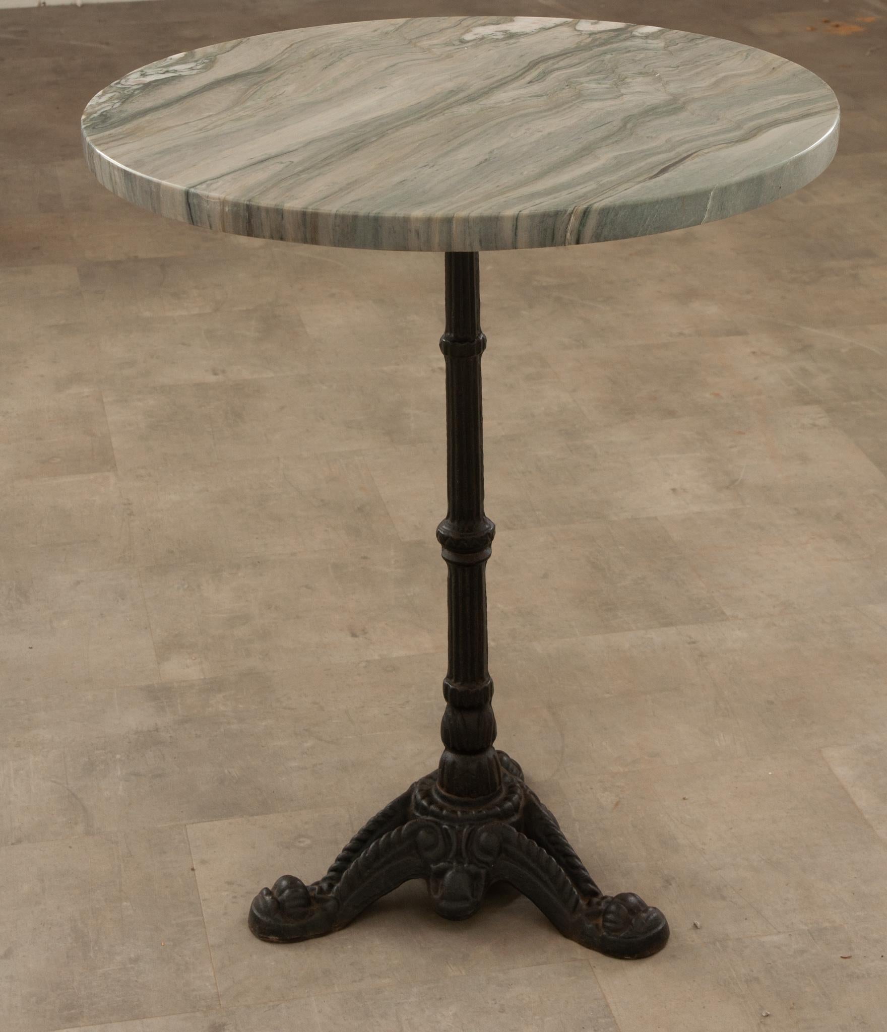 A classically designed French marble top bistro table to elevate any outdoor space. The wonderful new fusion stone top is affixed to the cast iron base and remains quite level. A three foot base continues to provide a stable foundation. The whole