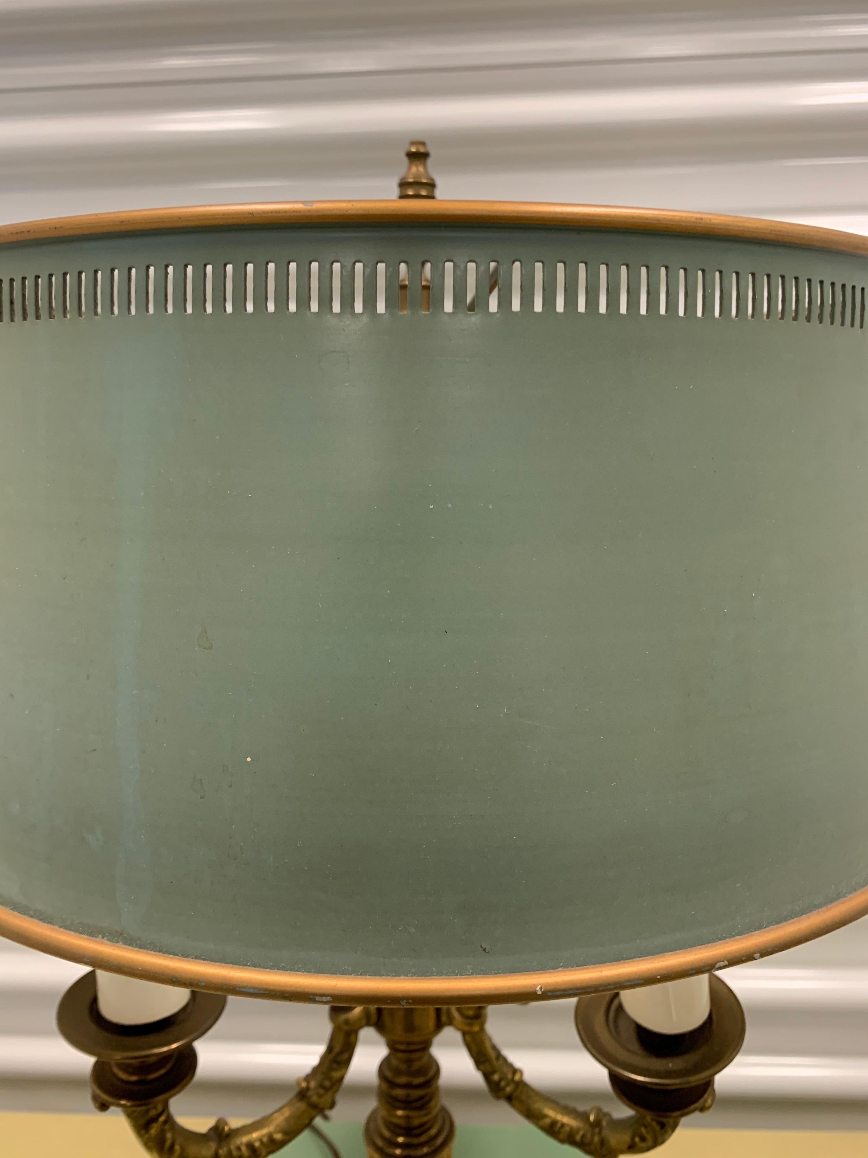 Elegant French Bouillotte brass lamp. Wired for USA and with original metal shade. Features three lights.