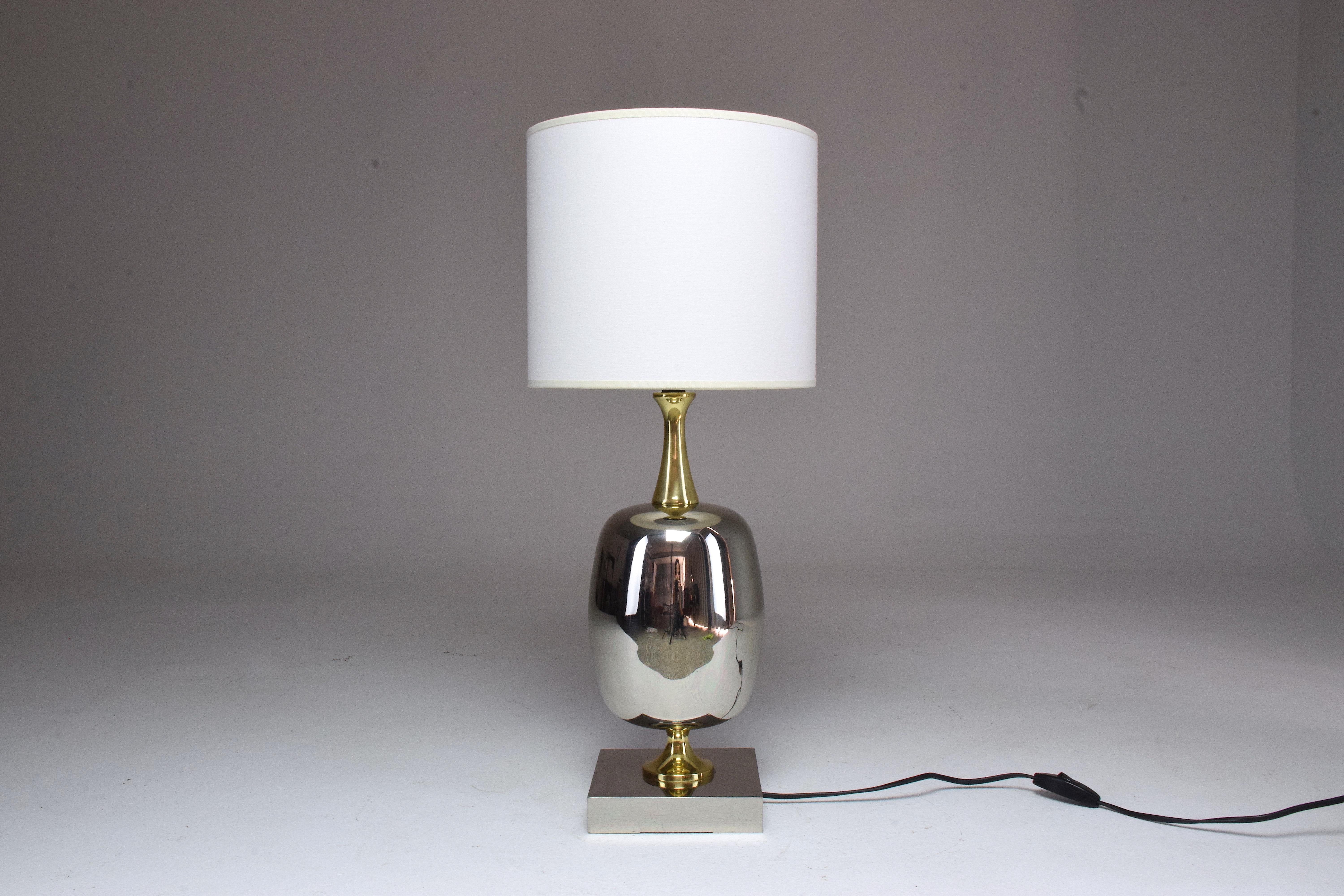 A 20th-century French vintage table statement lamp fully restored in nickel-plated brass, gold polished brass details, and new cylinder fabric shade. The main part of the lamp was originally brass plated which we stripped of to reveal the silver.