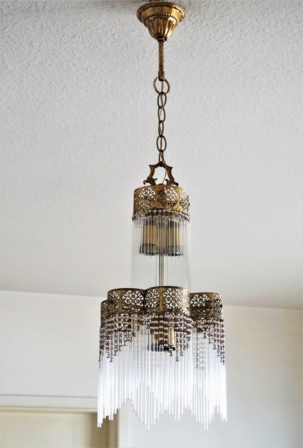 Lovely Art Nouveau style gilt brass three-light chandelier with glass rods and rose color glass pearls impressive lighting effect!


Measures:
Total height 31.50 in (80 cm) - hanging chain can be shortened
Diameter 9 in (22 cm).
  