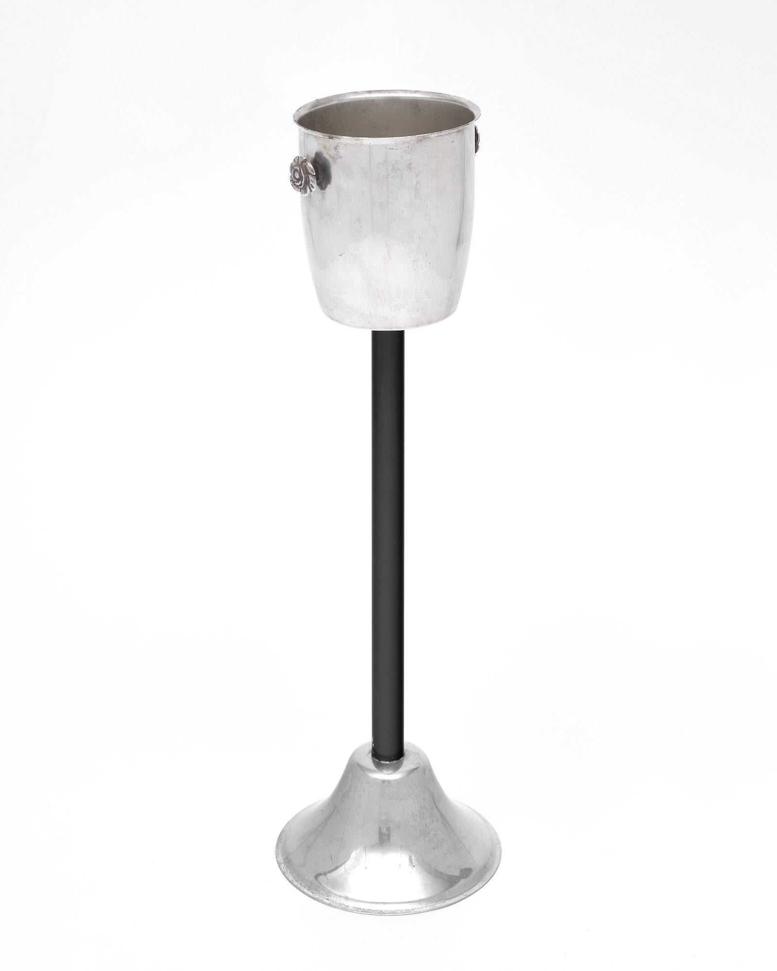 French champagne bucket on stand. This piece features a silver plated bucket sitting on a black lacquered stand.