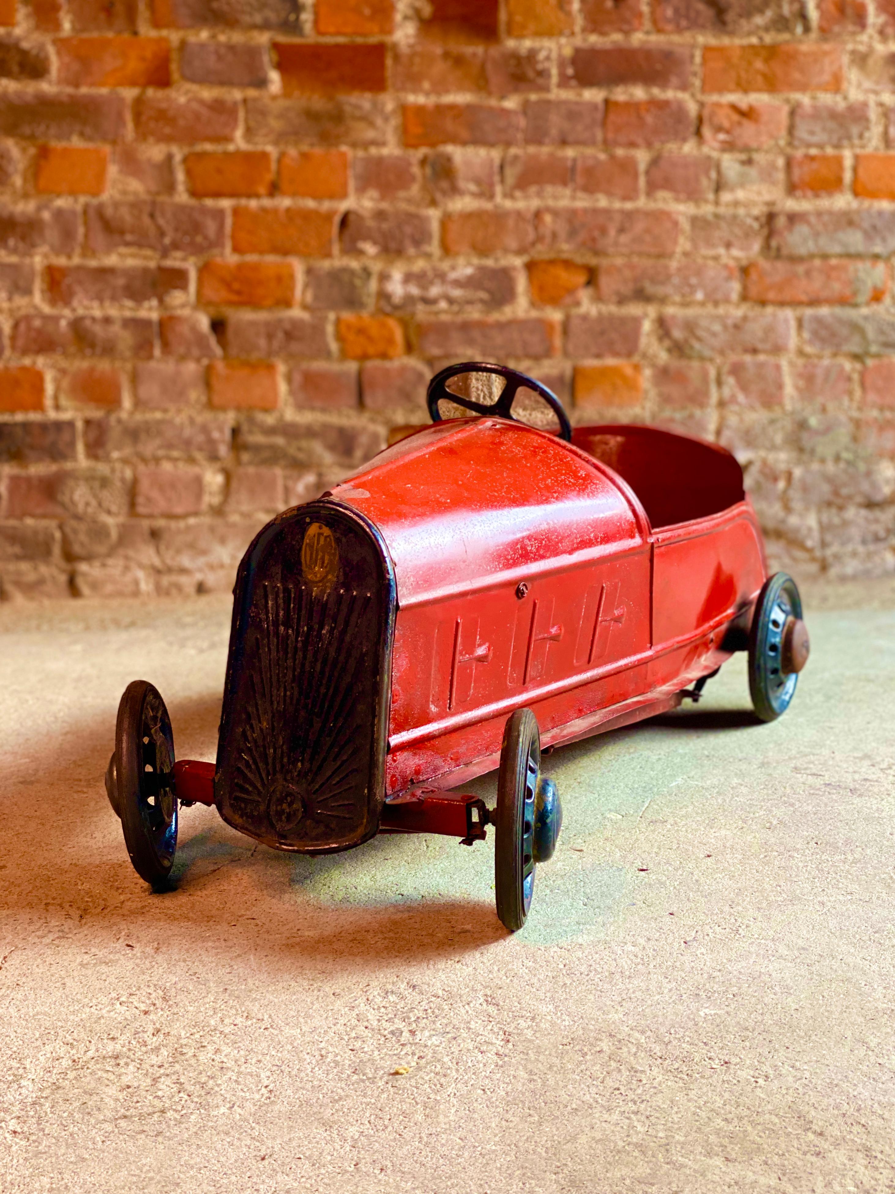 French vintage child’s pedal car metal Art Deco era, circa 1930s

Magnificent vintage French child’s metal pedal car, circa 1930s, typically French in styling, this super two-door sports coupe with maroon body, with four wheels with solid rubber