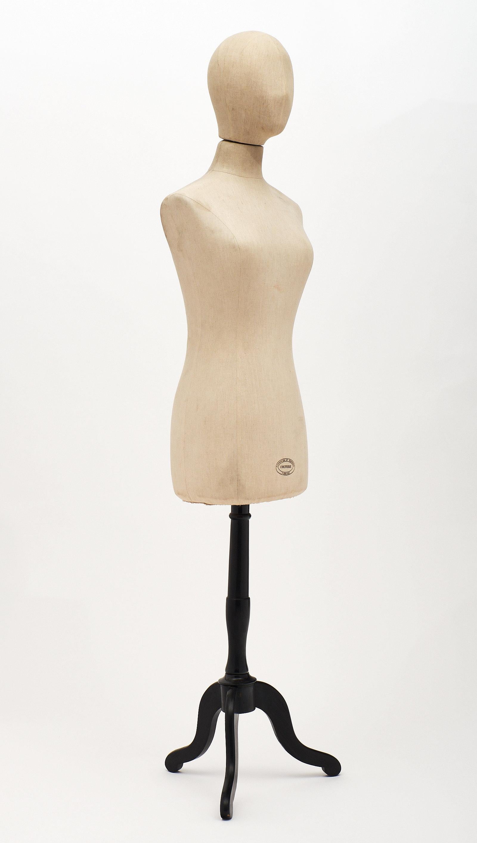 Vintage French couture mannequin on an ebonized wood stand. The stamp on the bottom reads: “Faubourg St Honore; Paris VIII; Couture”.