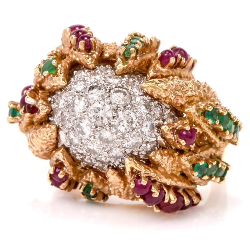 This chic 1960s diamond, ruby and emerald cluster dome ring is crafted in solid 18k gold and platinum. Displaying a platinum center of clustered round-cut diamonds approx. 2.59 carats, graded G-H color, and VS1-VS2 clarity. Surrounded by leaf like