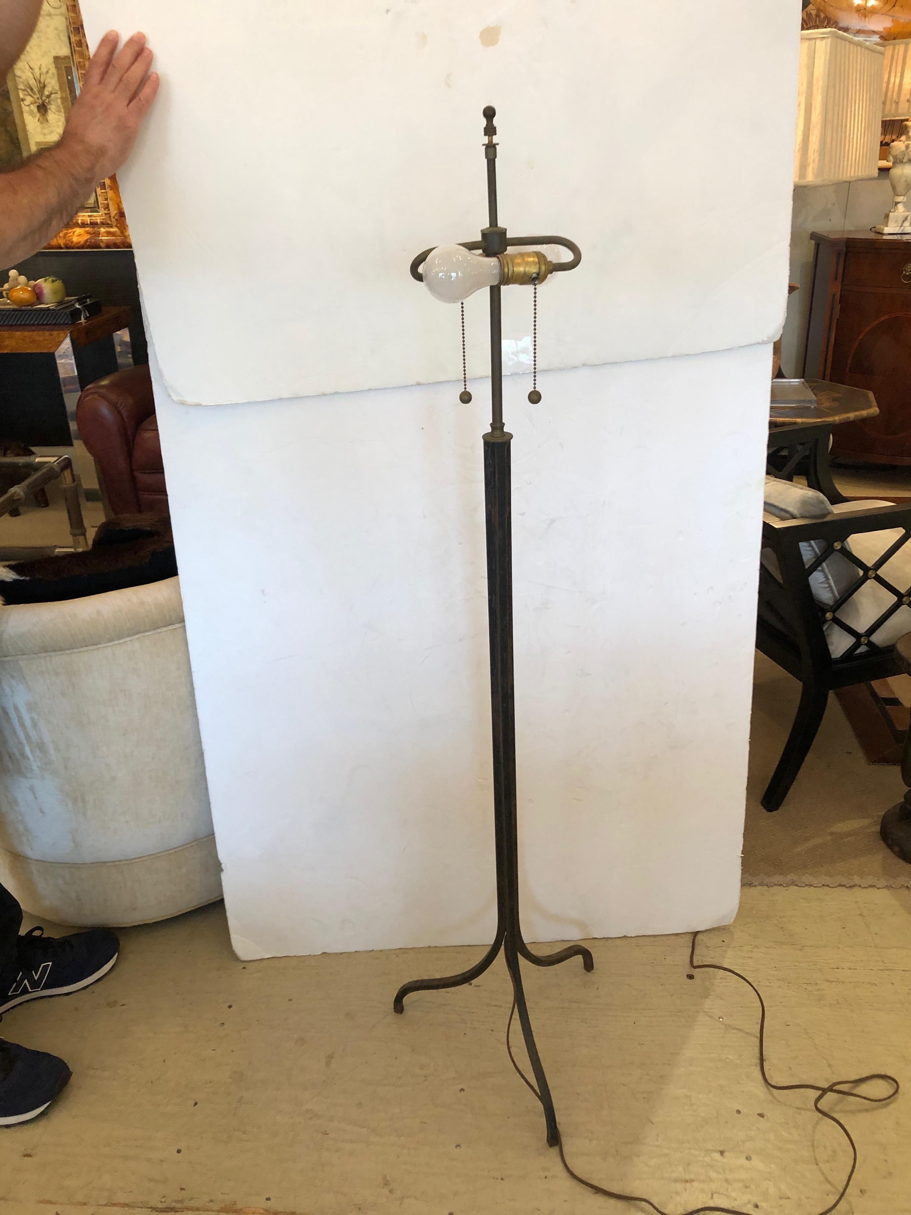 Fantastic floor lamp having a sleek Directoire steel base on 3 elegant legs and a handmade one of a kind shade dreamily adorned with authentic brown and cream feathers.