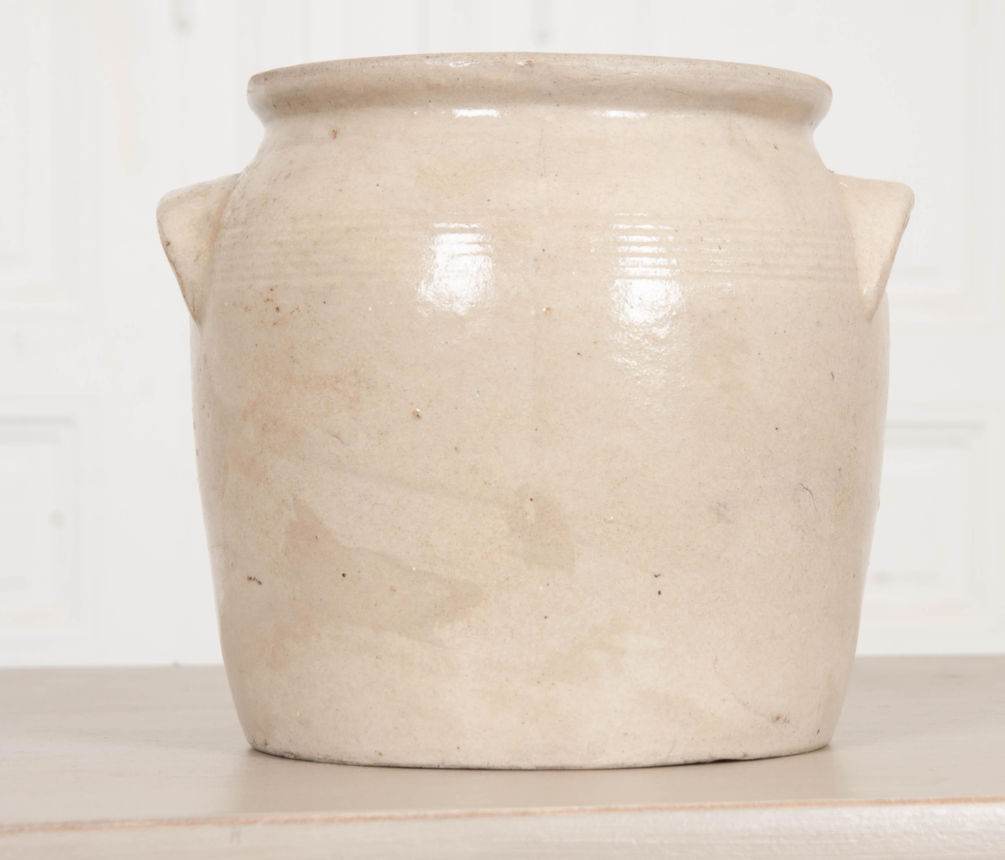 This vintage Provincial glazed earthenware crock is from France. Its cupped handles make lifting the pot a little easier, and the decorative banding found between them gives it a distinct style. Every ceramic pot will differ slightly, as they are