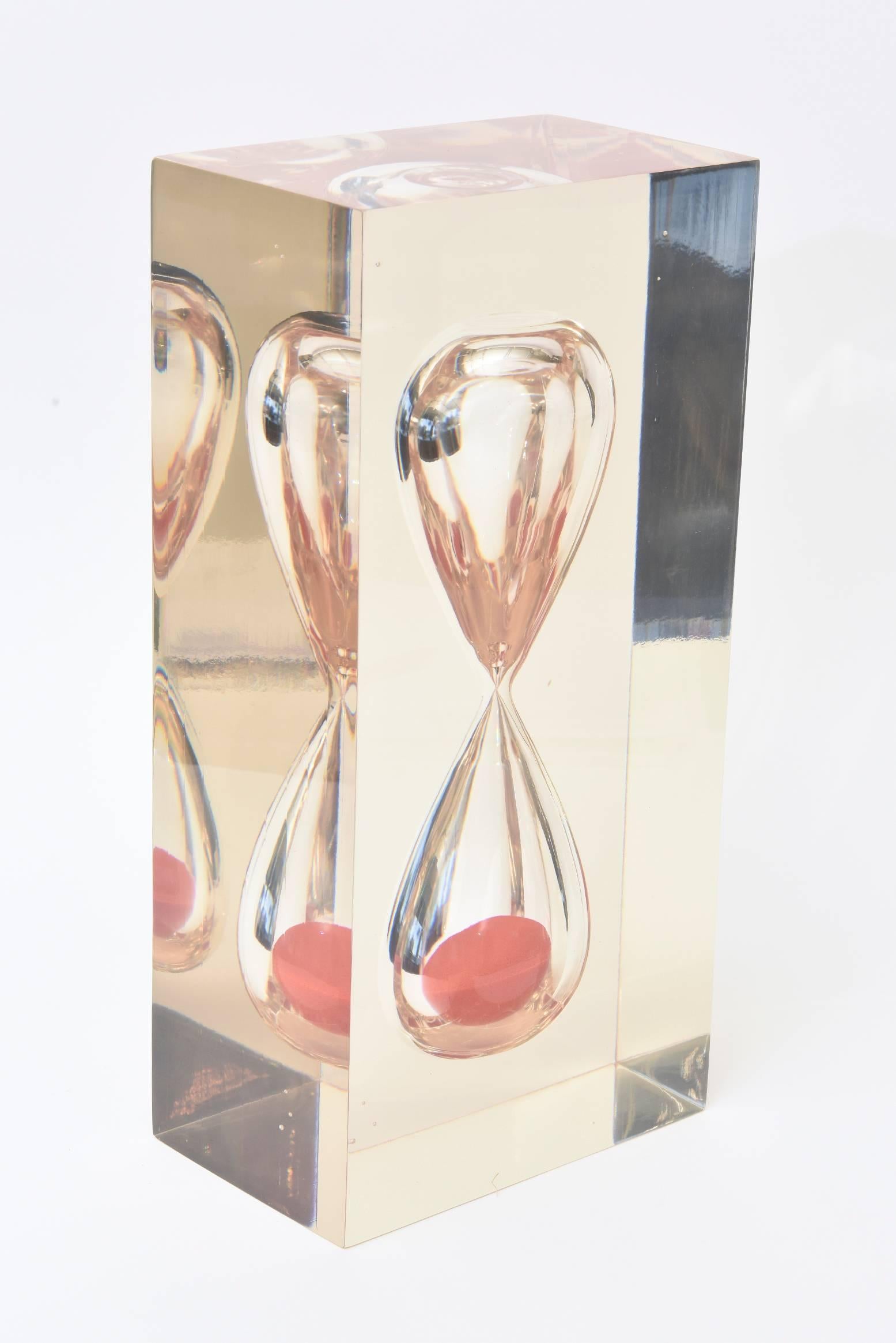 This fantastic vintage French encased large Lucite hourglass object /sculpture is mesmerizing. The orange sand adds punch. It is heavy and substantial and amazing. It is from the 1970s and the Lucite has been polished to the best it can be.
It is