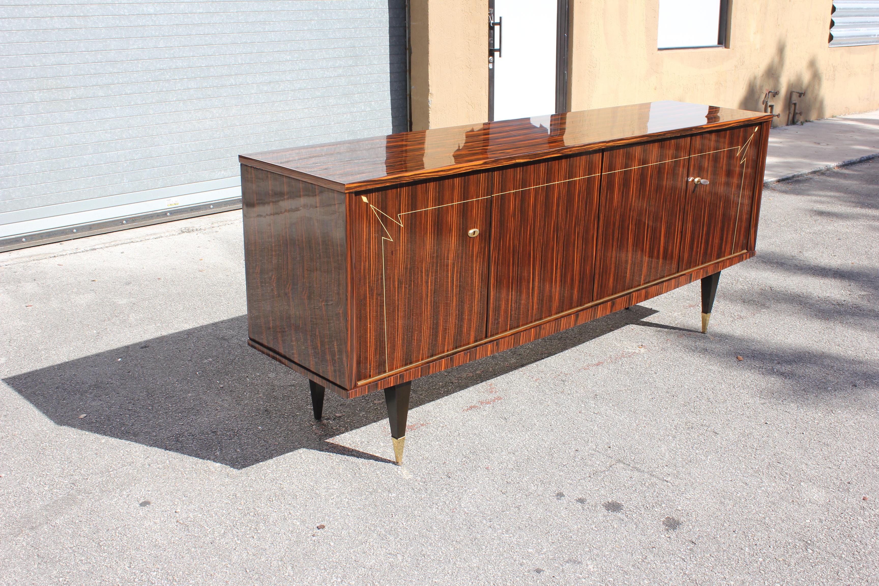 Beautiful French Art Deco exotic Macassar ebony diamond mother of pearl sideboard or buffet, circa 1940s. This piece displays very high levels of craftsmanship ,The sideboard are in very good condition, with 3 shelves adjustable, and you can remove