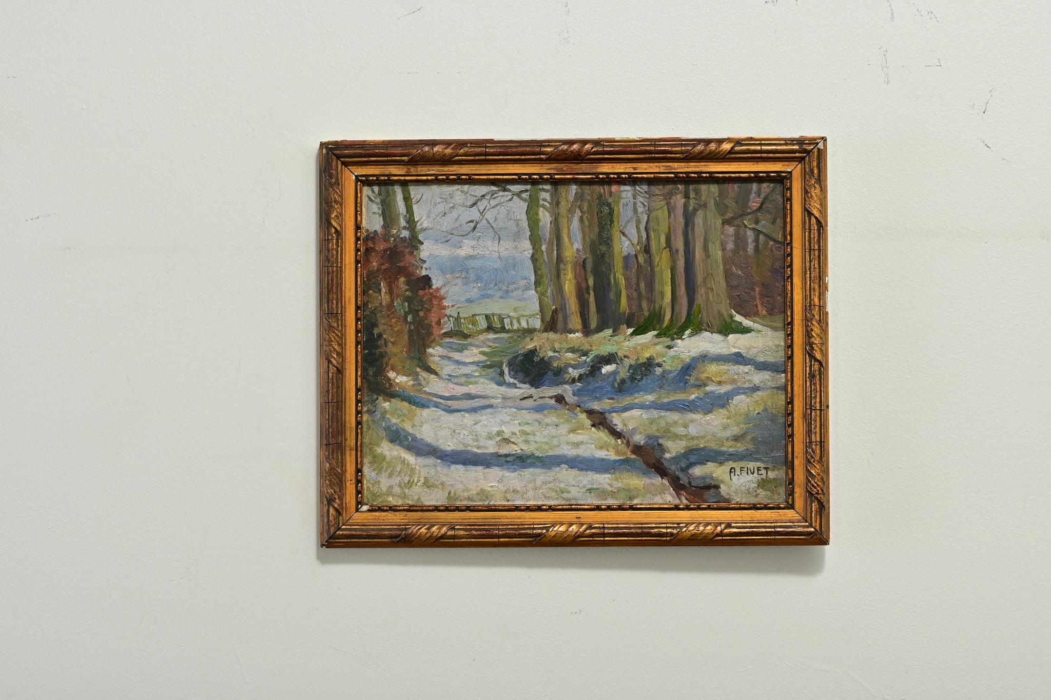 A beautifully solemn winter woodland scene is depicted in this vintage oil painting from 20th century France. A stand of leafless trees borders a rudimentary road, beyond which a fence can be seen. Long, cast shadows from trees which are out of view