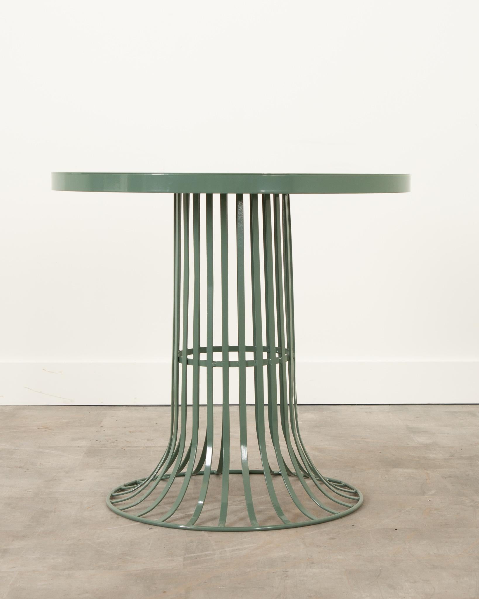This charming French garden table is the perfect combination of sleek design and sturdy material. Made of iron, it’s been sandblasted and powder-coated for protection against the elements. The base is originally a vintage French trash bin that’s
