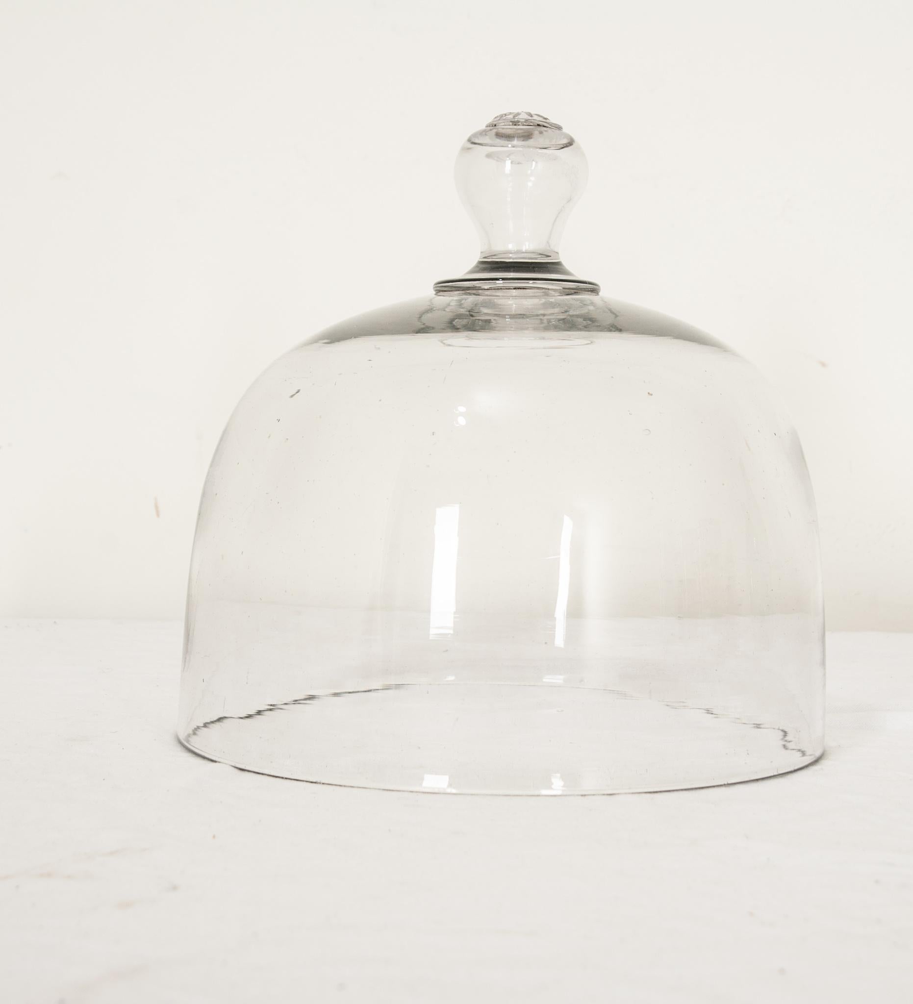 Vintage French diminutive clear glass cheese or cake dome. This dome of lovely hand-blown glass is perfect for displaying fruits, small cakes, cheeses, or breads. Can be paired with a cutting board or antique china. Perfect for showcasing petite