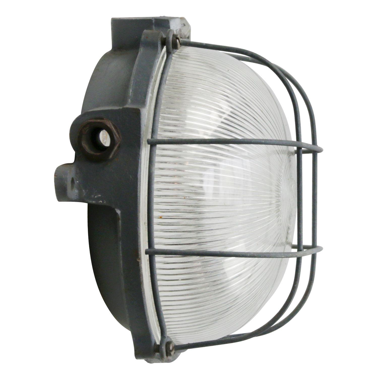 French Industrial wall / ceiling lamp
Cast iron back with clear striped glass.

Measure: Weight 2.80 kg / 6.2 lb

Priced per individual item. All lamps have been made suitable by international standards for incandescent light bulbs,