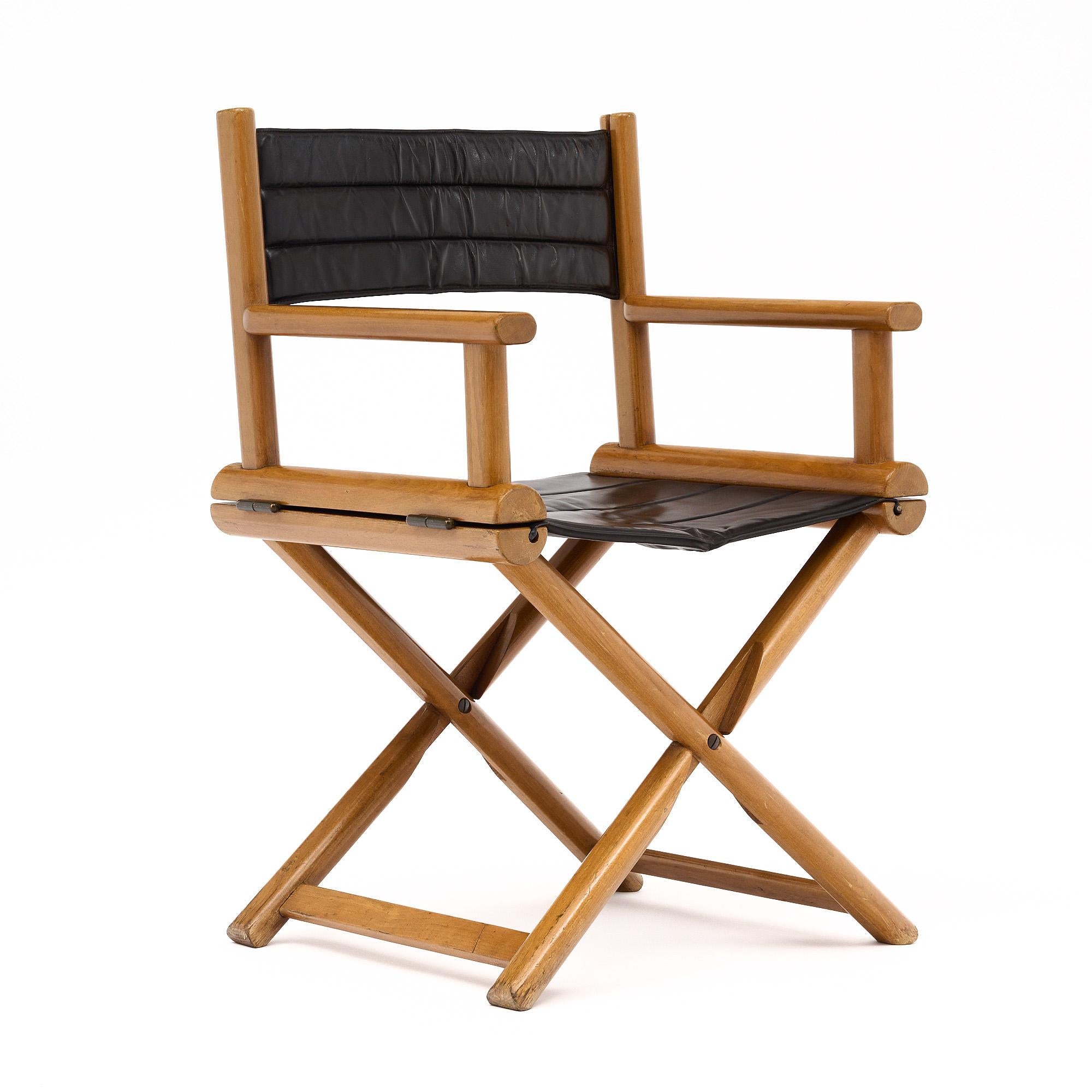 Set of four folding chairs from France made with walnut wood structures and leather seats and backs. Each comfortable chair has a classic folding chair shape with x-shaped legs. The seats and backs are upholstered in the original dark brown stitched