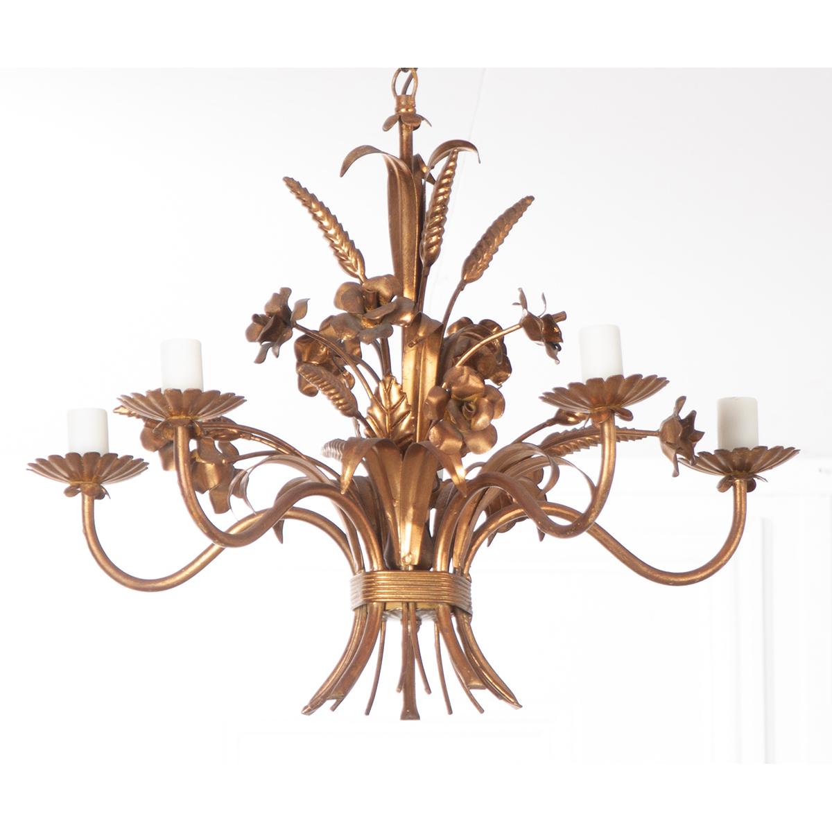 A wonderful little five light vintage chandelier from early 20th century France. The fixture is designed with sweet floral imagery and other foliate details that form a bouquet like none other. The petite fixture is made of wonderfully painted metal