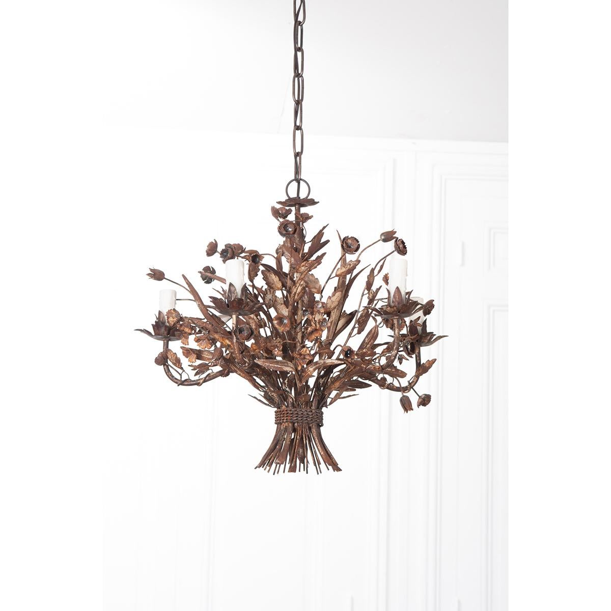 A charming vintage five light metal chandelier from early 20th century France. Beautifully made in delicate metalwork with dainty flowers, leaves and twisting vines all bound by a rope, a real artpiece adding a certain French ‘je ne sais quoi’ to