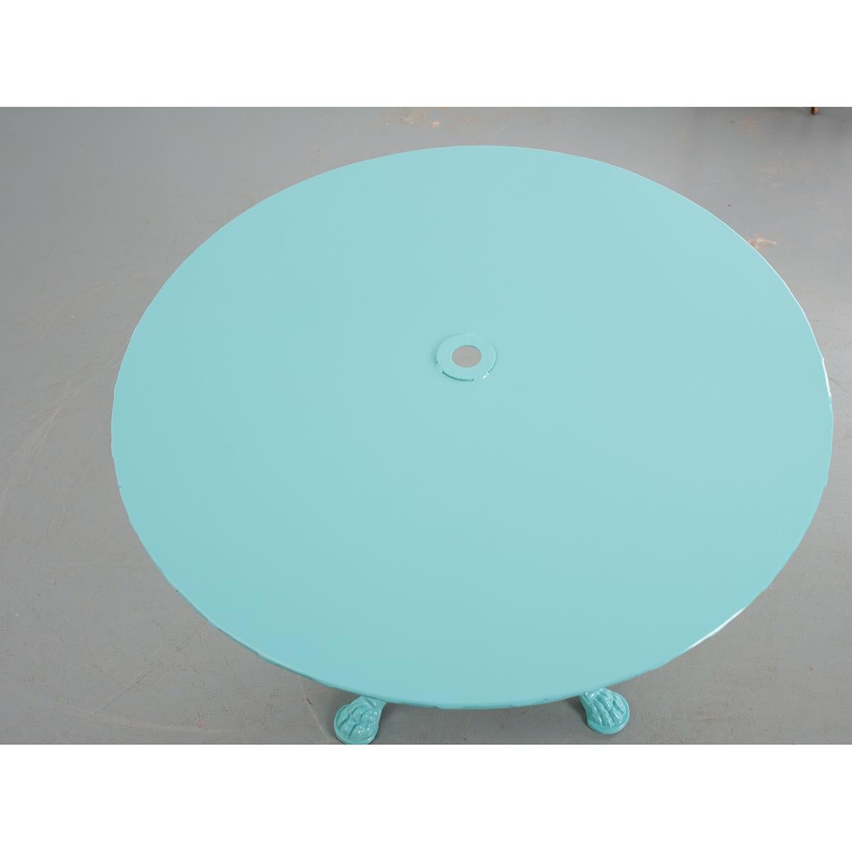 This is a French vintage metal garden table. It has been recently sandblasted and powder coated for weather protection. The colorful table would liven up any garden.