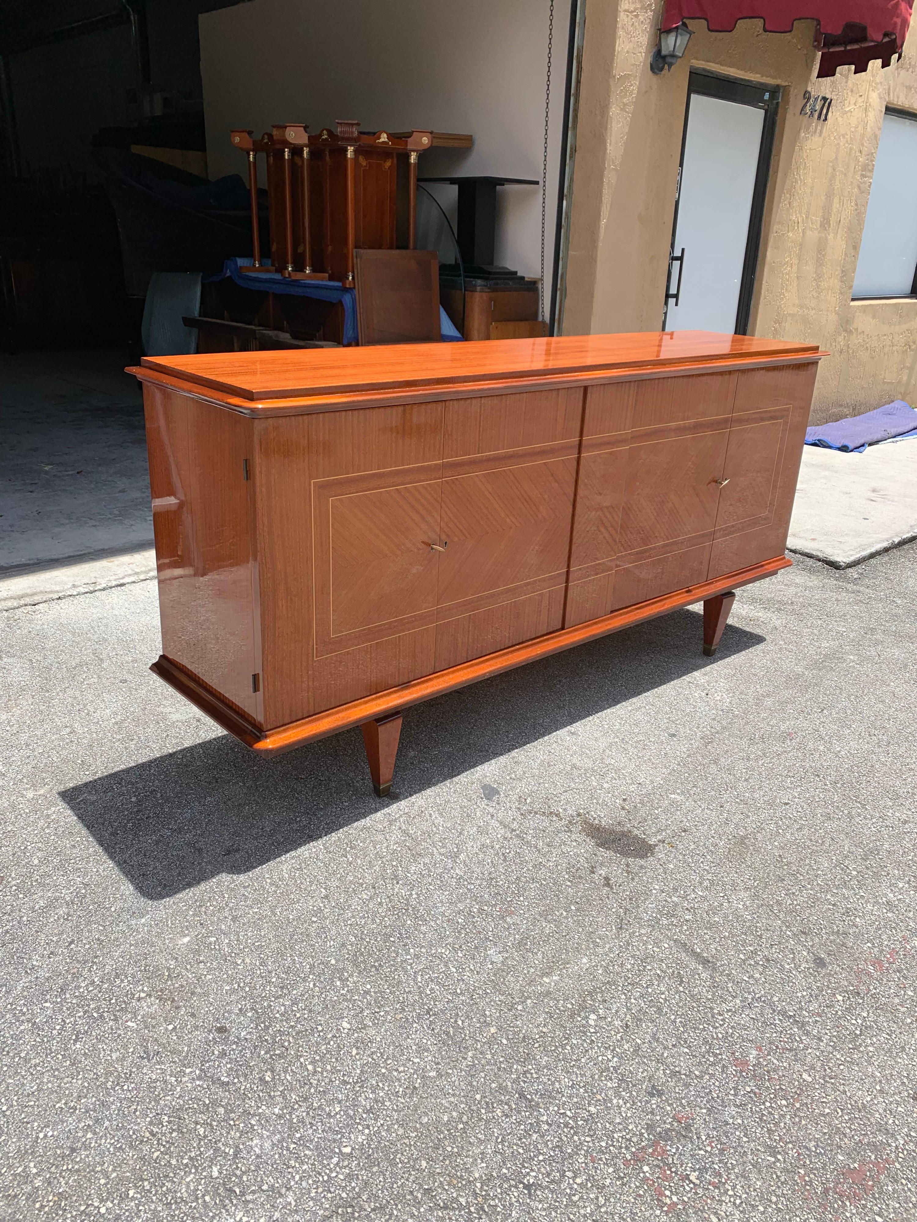 French exotic mahogany sideboard or buffet, circa 1940s. This piece displays very high levels of craftsmanship, the sideboard are in perfect condition, with 3 shelves adjustable and you can remove all the shelves if you need more space, with 2