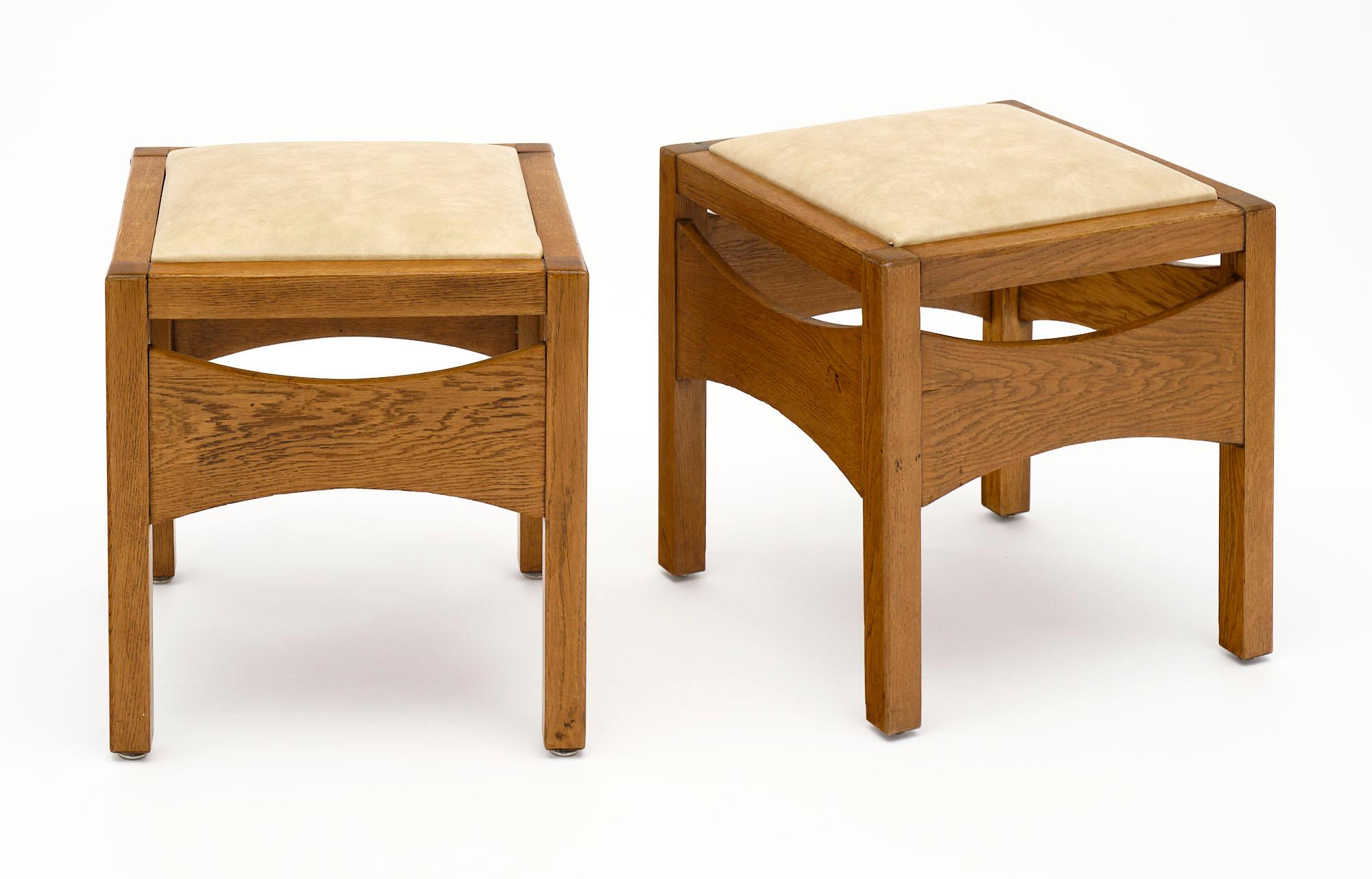 Pair of stools from France made of solid waxed oak in the style of Charlotte Perriand. The skai upholstery is original.