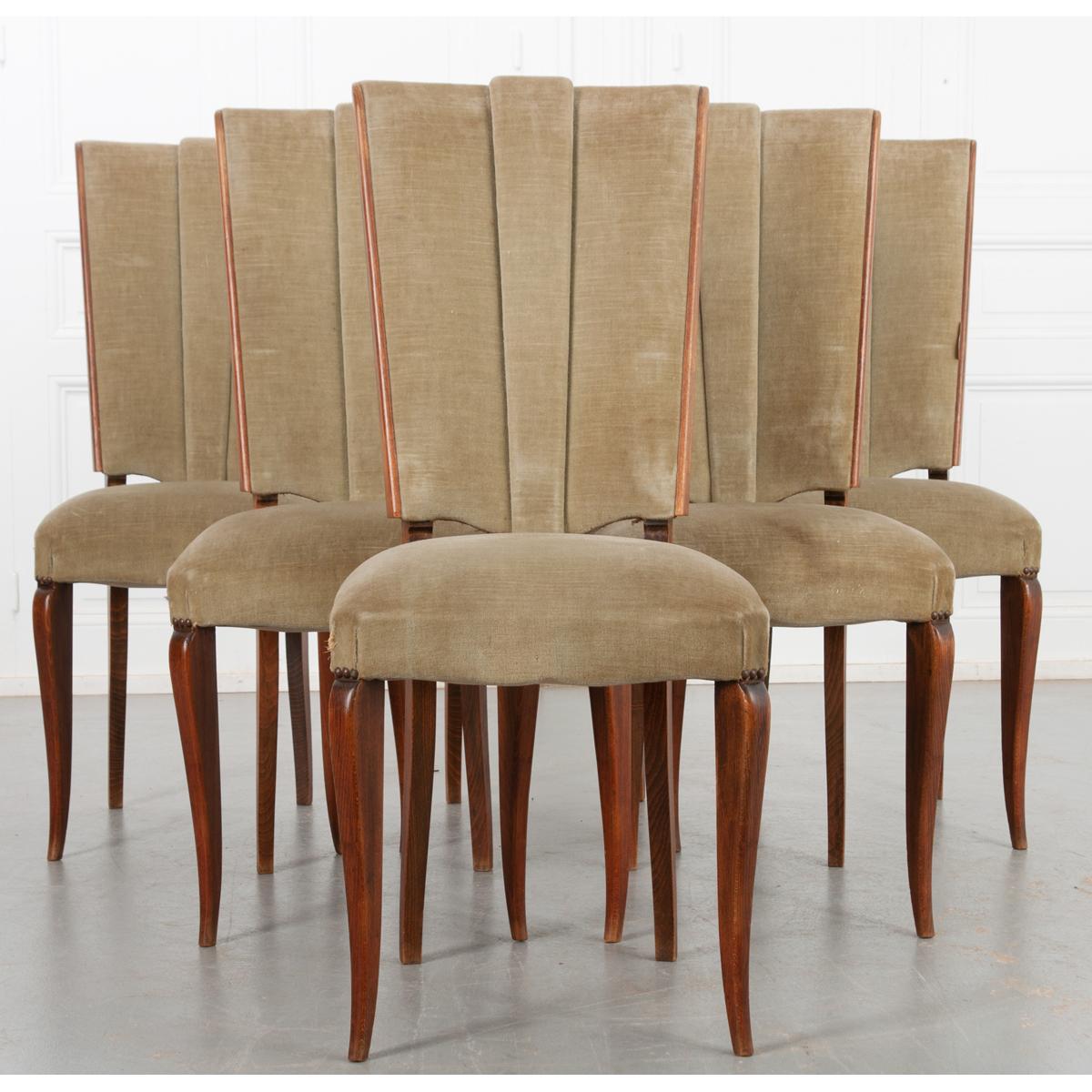 This lovely set of six dining room chairs are made of oak and velvet upholstery. Comfortable, nicely shaped seat backs have a wonderful vintage quality. Sleek, polished legs support the chairs and compliment the overall design. There are some signs