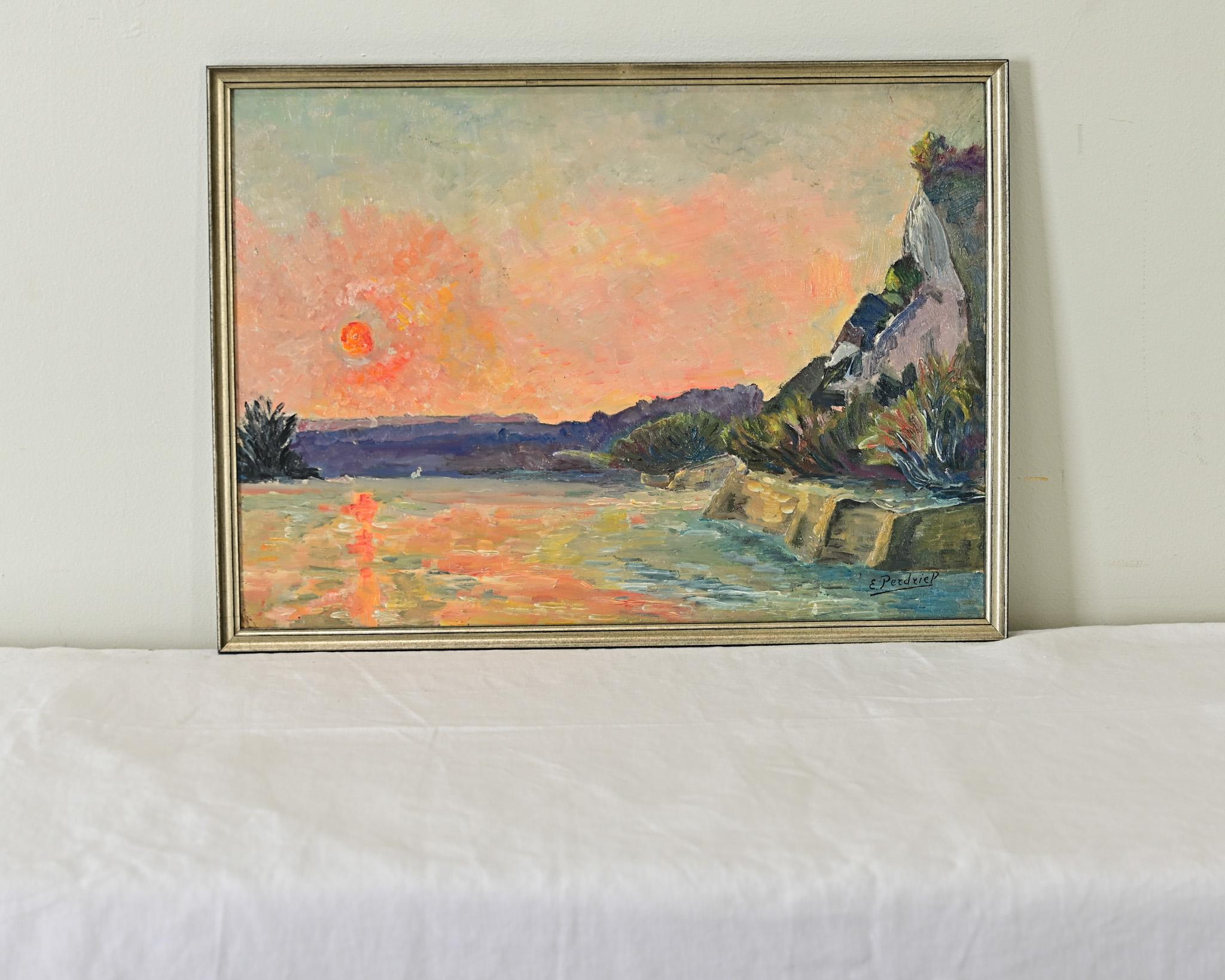 Lovely pastel colors from turquoise to pink and lavender animate this vintage French oil painting of a coastal scene at sunset. The fiery glow of the setting sun behind a purple horizon line burns though the hazy cloud cover and is reflected in the