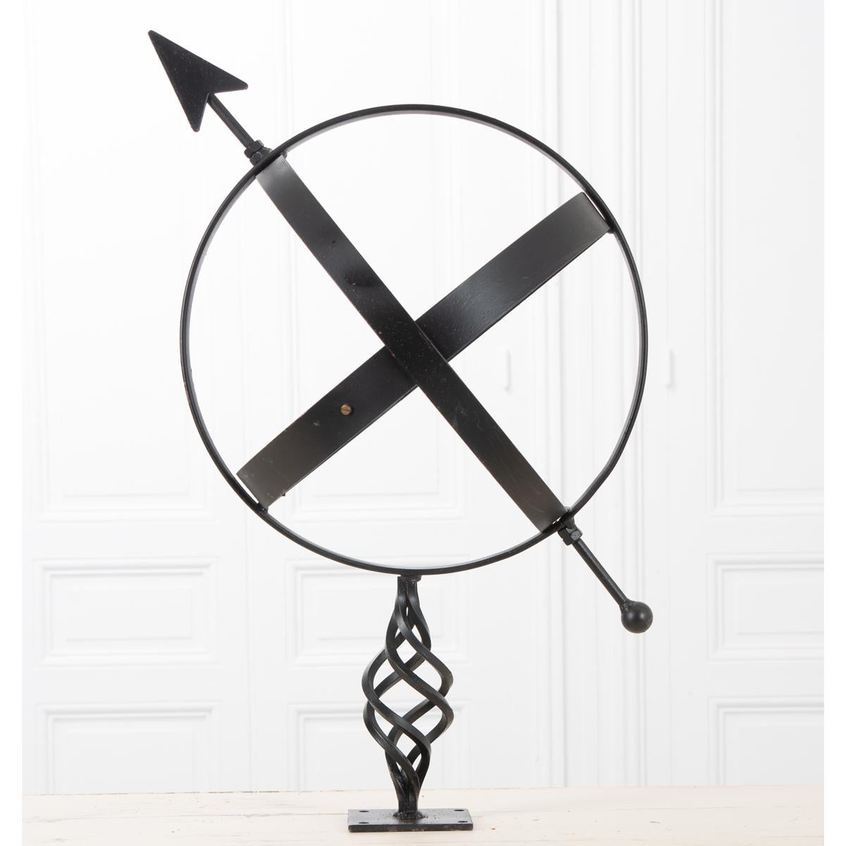 A great vintage iron armillary. The armillary has a black painted finish with an accent of brass. This piece is intended for ornamental use.