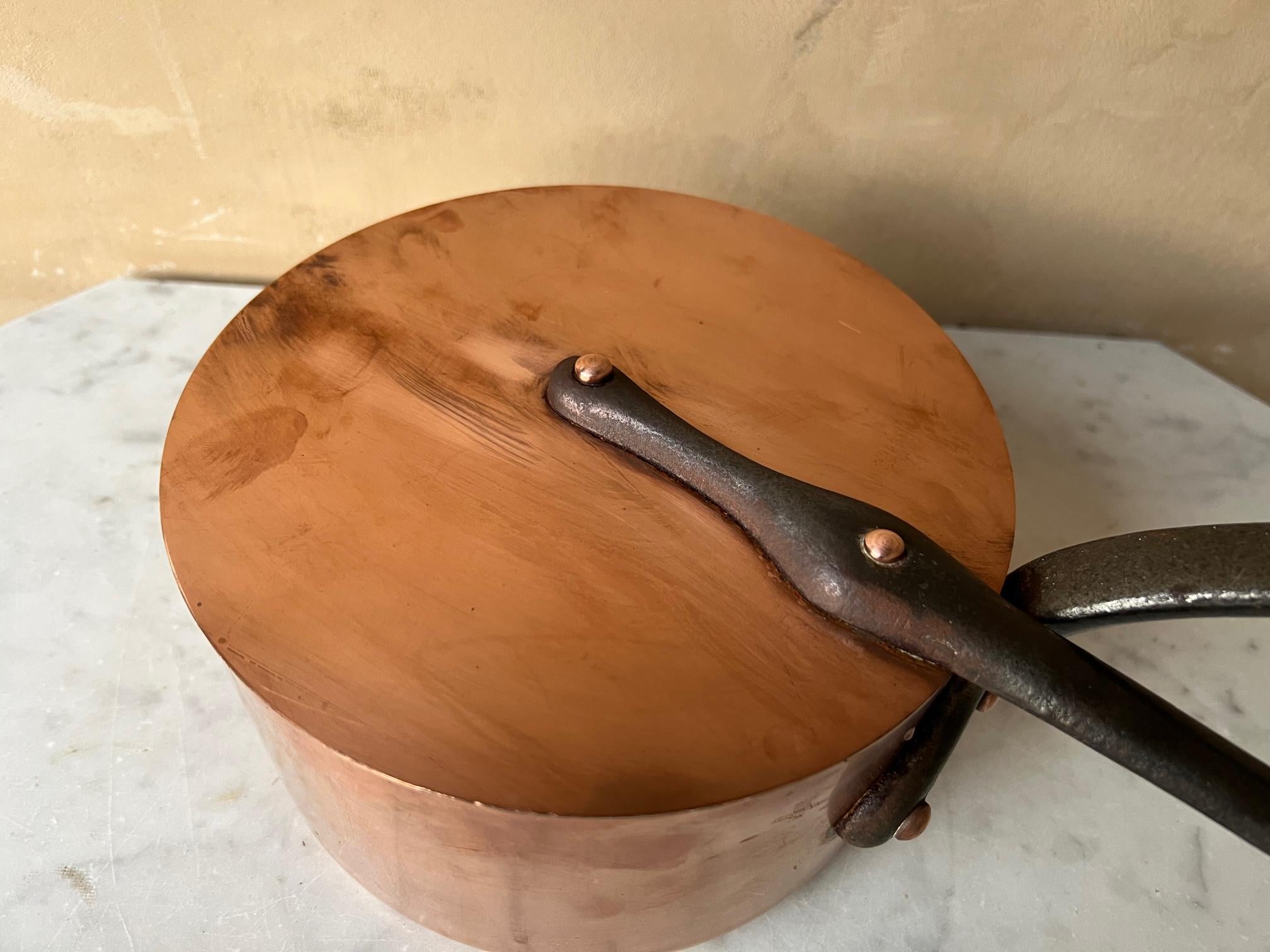Vintage French copper professional sauce pan and lid. The copper pot and handle have long cast iron handles with copper rivets and loops at the top for hanging each. Each piece has a layer of tin and ready to use.

The pan is stamped La Cuissinier