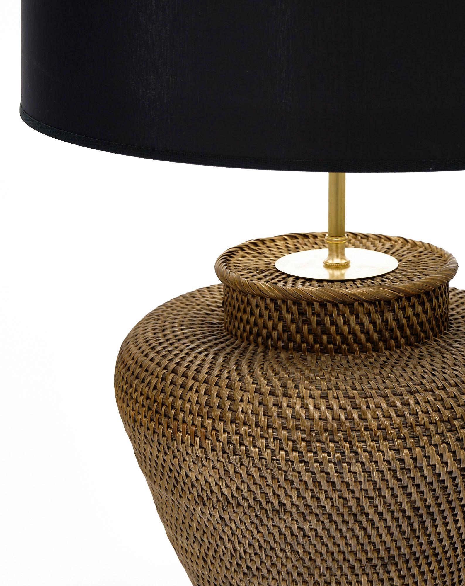 French vintage rattan table lamp with brass and woven rattan. This piece has been rewired to US standards with a 3 way bulb.