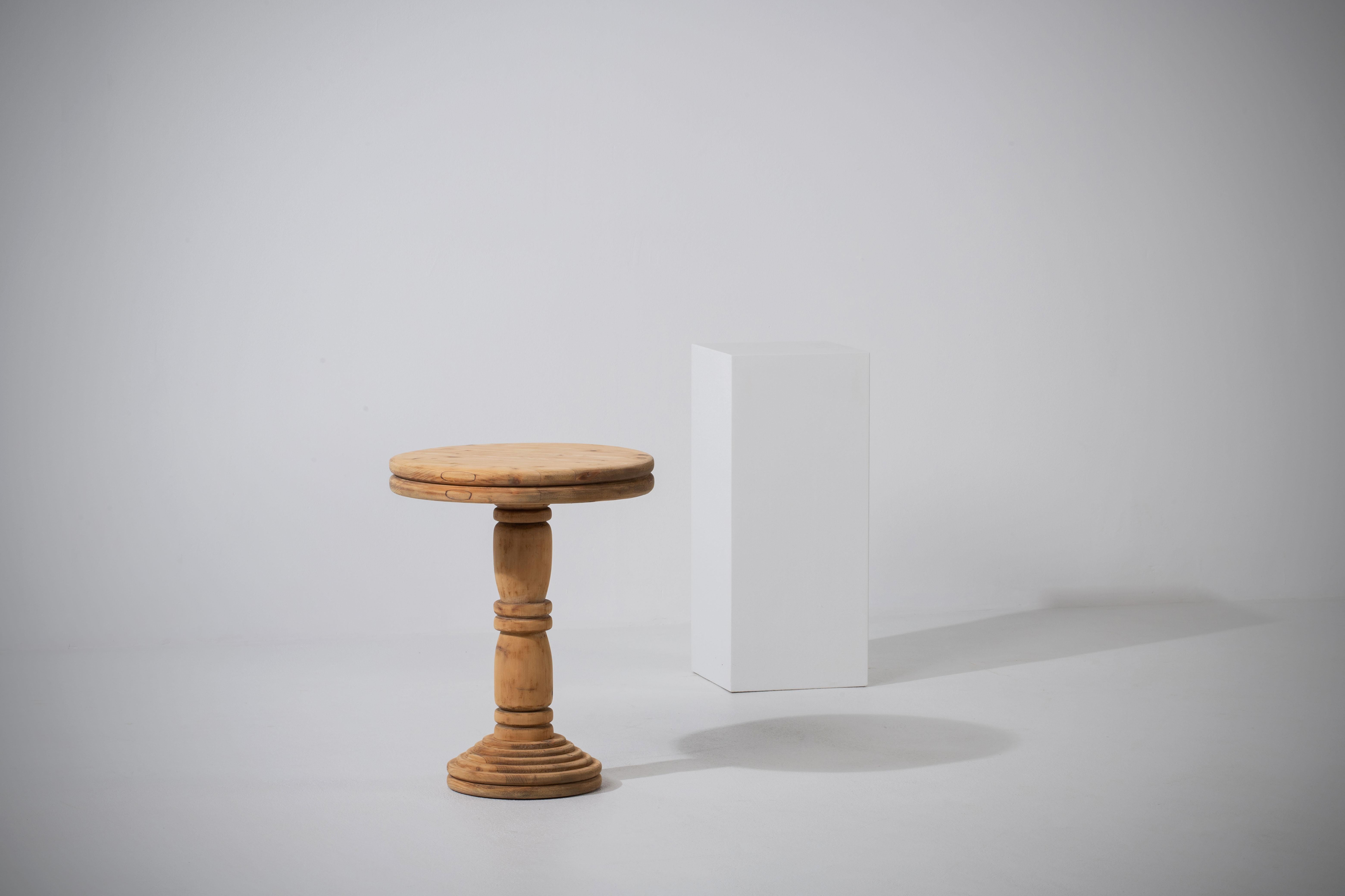 Introducing a captivating French vintage raw pine pedestal, originating from the 1960s and exuding timeless elegance. This versatile piece serves as a charming end table, adding a touch of refinement to any living room, or as a pedestal to showcase
