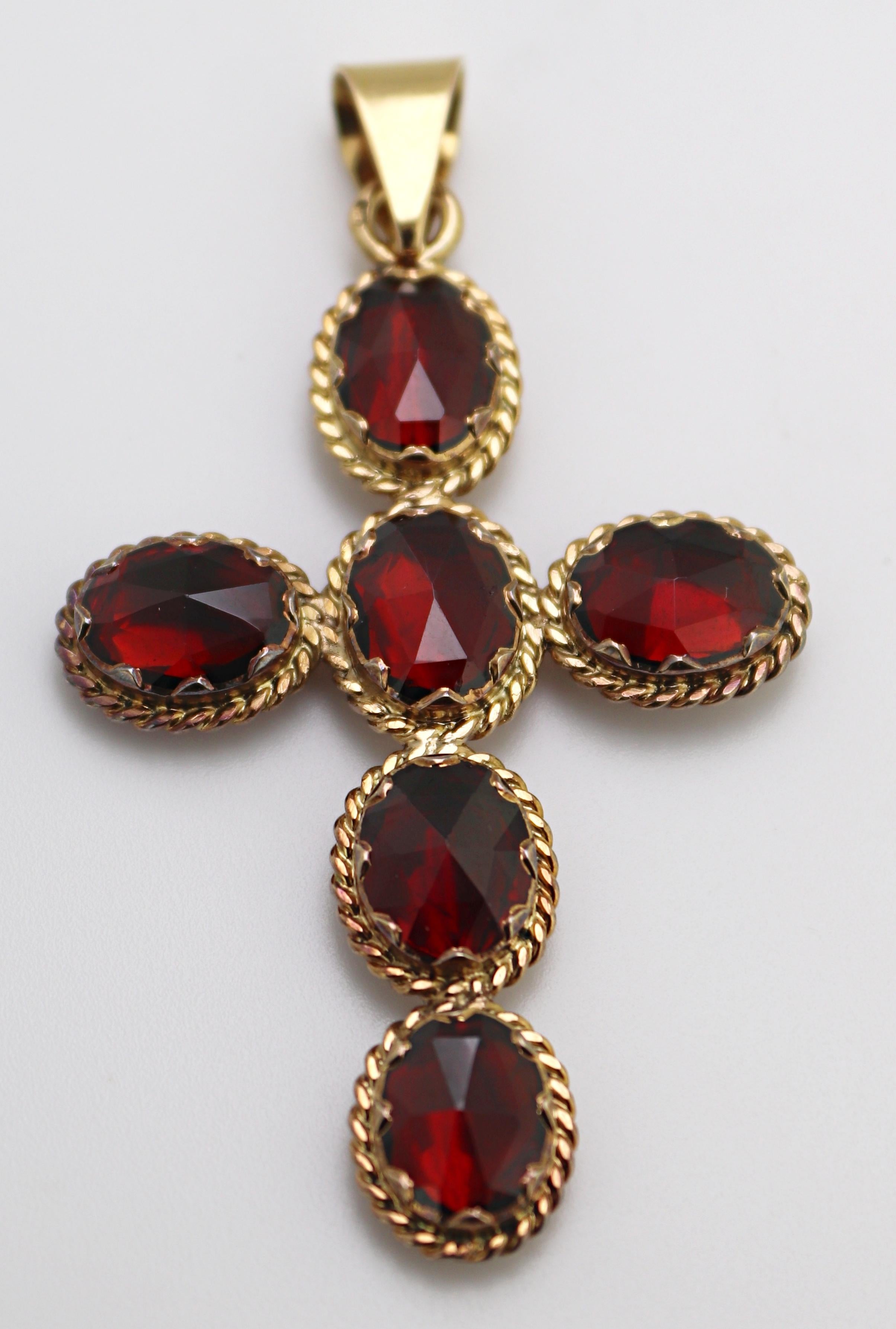 Featuring (6) rose-cut oval rhodolite garnets, 9.5 X 7.4 mm, each collet set
and foil backed in an 18k yellow gold cross mounting, 57.9 X 32 X 4.8 mm,
marked with French 18k hallmark, MC, Gross Weight 6.50 grams.