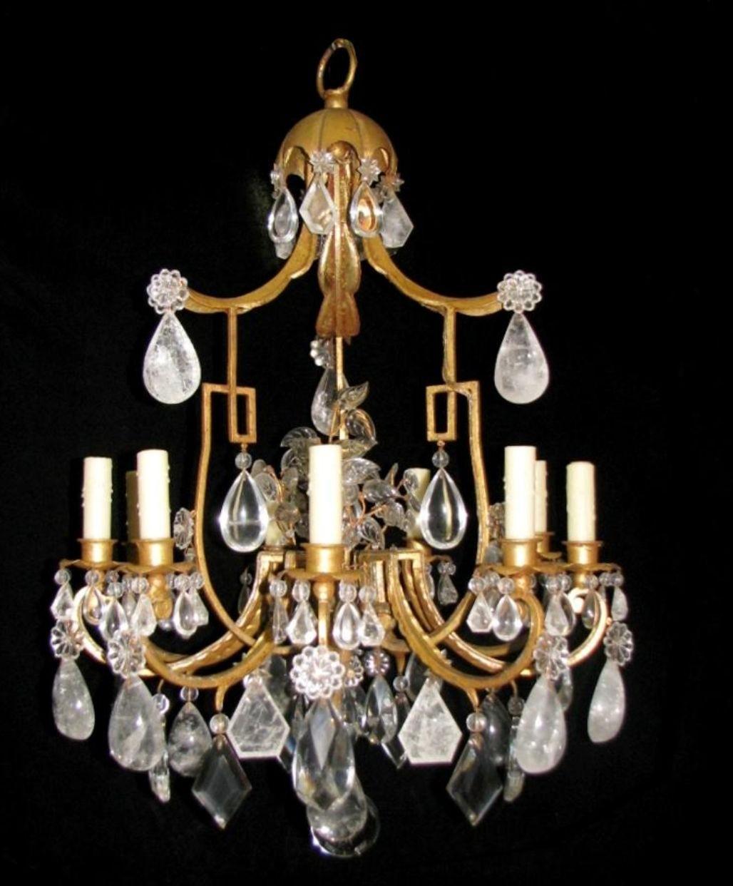 Un sorprendente lampadario realizzato in Francia nel XX secolo, a sei luci e composto da una struttura in ferro battuto con finitura a foglia d'oro 23k, da seducenti pezzi in cristallo di rocca e da una figura di uccello in cristallo di rocca