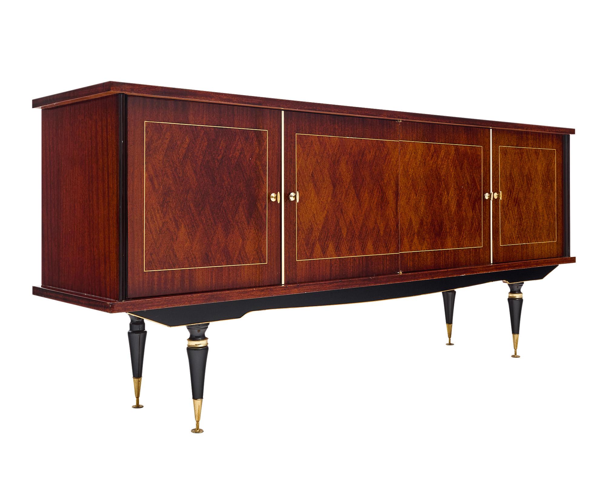Vintage buffet from France made with a rosewood parquetry façade and ebonized detailing on the tapered legs and column sides. Four doors open to reveal interior shelving with a dovetailed drawer on the right and a drop down bar on the left. There is