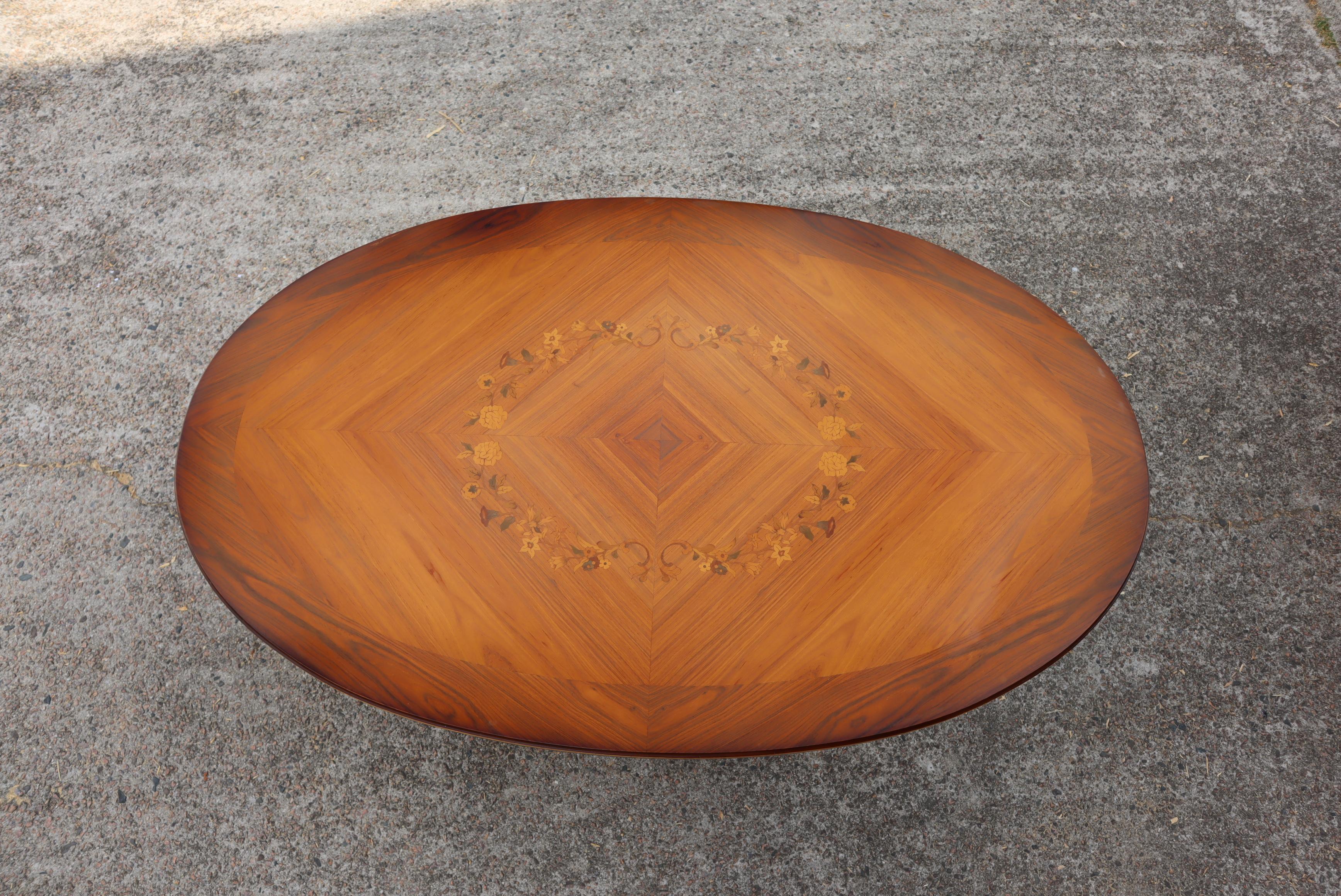 A stunning, fine quality French Rosewood Coffee Table by J.P. Ehalt.
Exquisitely handcrafted using only the finest materials and highest level of craftsmanship,
Extensively inlaid oval shaped top, richly decorated marquetry at the center features