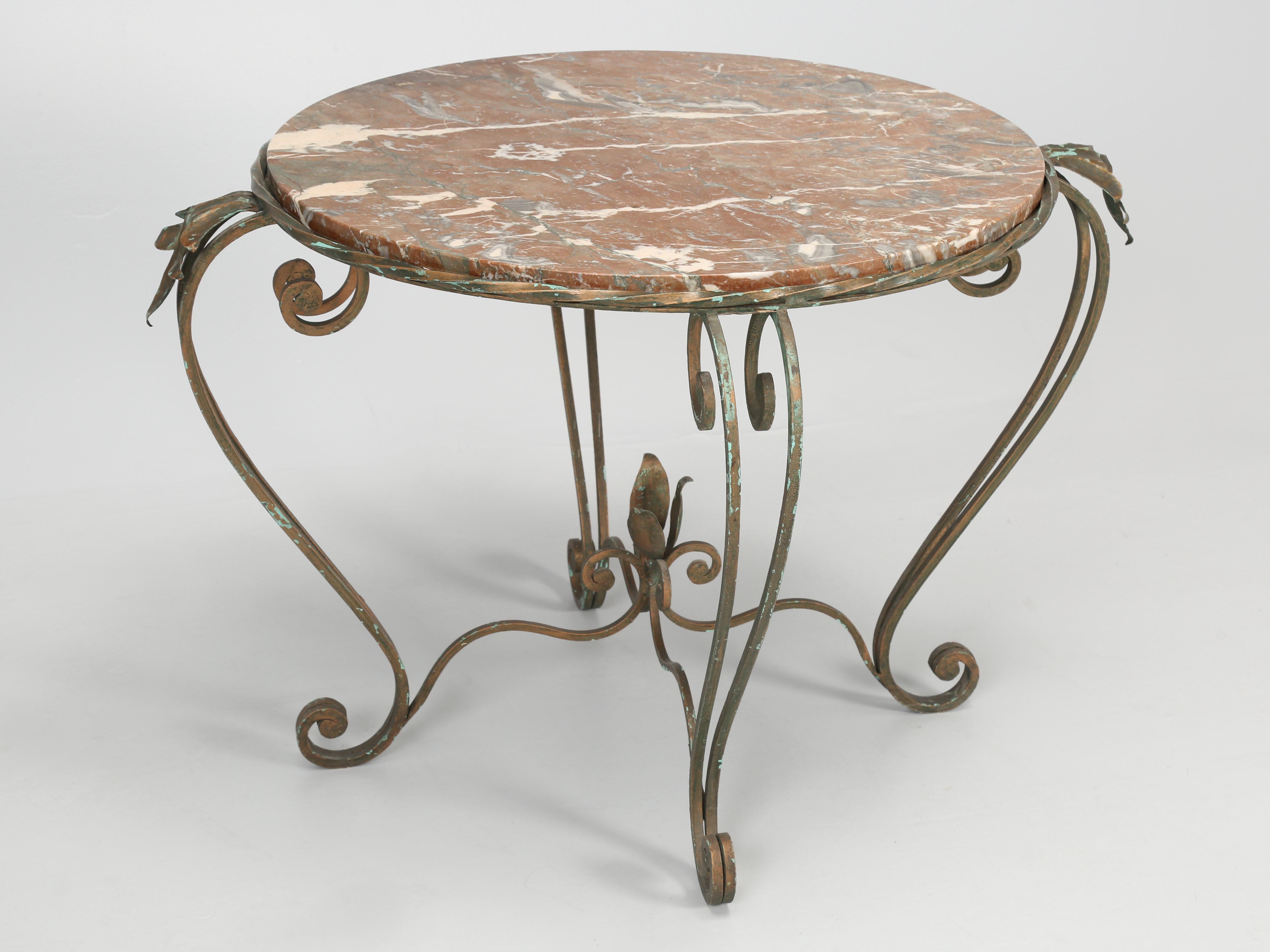 Vintage French hand-made wrought iron and marble side table or end table and possibly could be used as a coffee table. What is so great about this vintage French round side table is the finish. Our best hypothesis thinks it’s a cold plated bronze