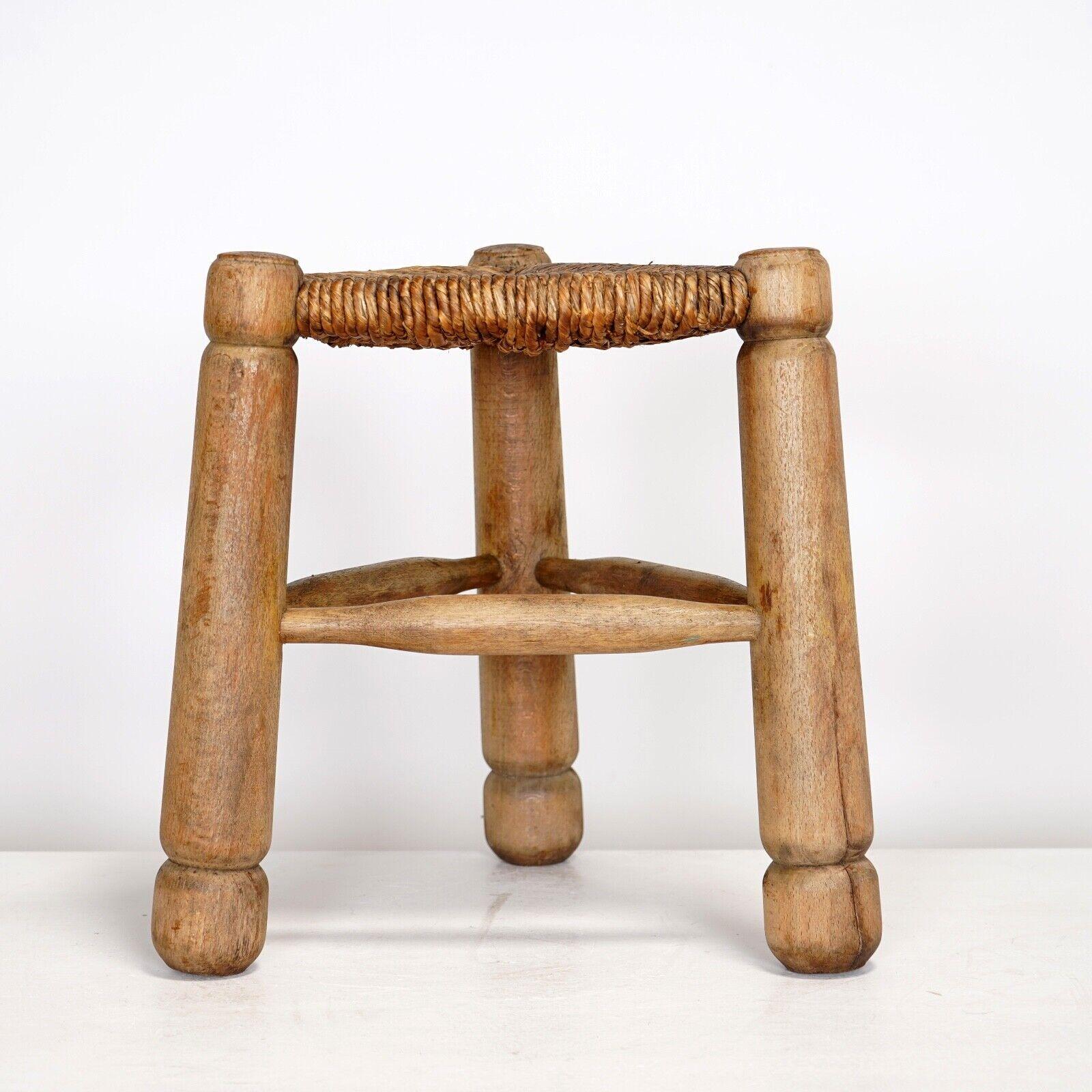 Triangular oak stool with rush woven seat in the style of Charles Dudouyt circa 1940s. 
Thick chunky legs with the round finials indicative of the French designer Charles Dudouyt. 
In good vintage condition, rush seat perfect. All round solid and