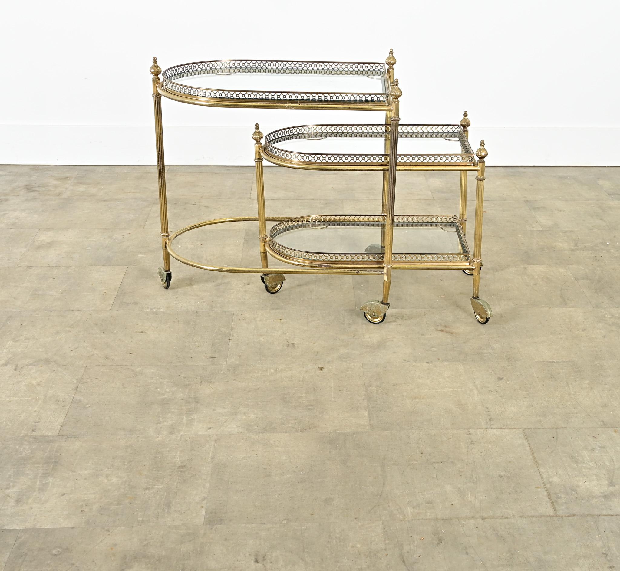 A fabulous pair of nesting trolleys from midcentury France in the manner of design legends Maison Baguès and Jansen, the brass and glass combination always looks chic to bring cosmopolitan glamor to any interior taste. The set is composed of two