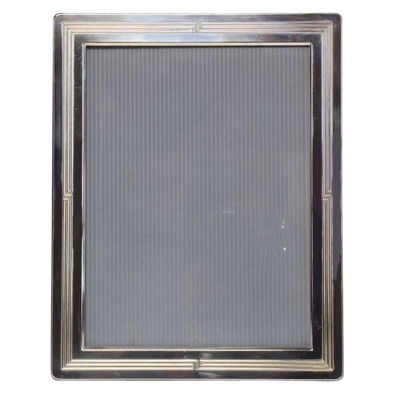 A 20th century vintage rectangular silvered metal picture frame with a varnish finish and wood in reverse. Stamped and signed Christofle.
France, circa 1960s-1970s.

 