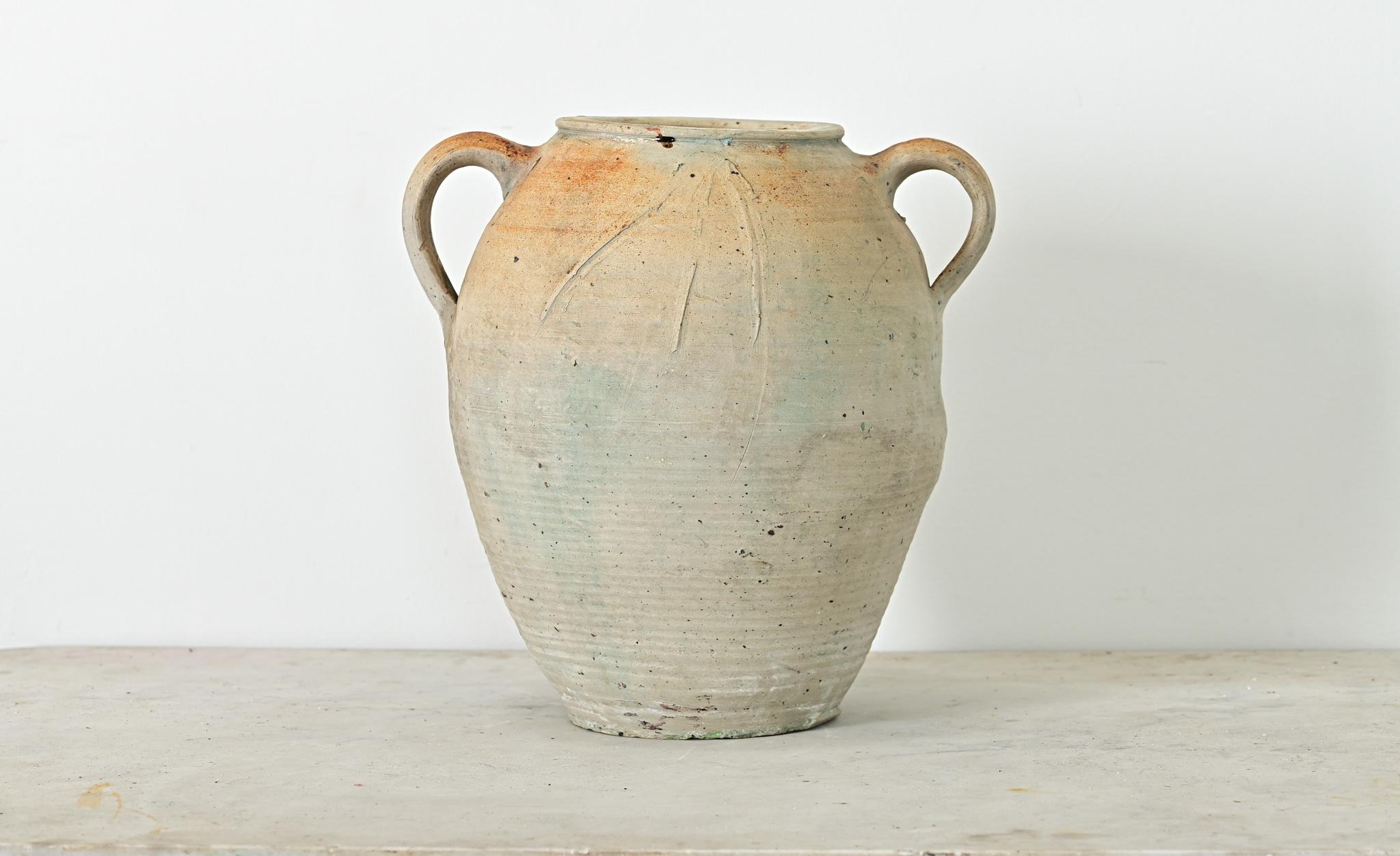 A French vintage glazed stoneware confit-type pot with a pair of handles for balance. This utilitarian Provincial vessel would have been used to store and preserve foods like a confit or rillette. Glazed on the exterior in an ethereal palette of