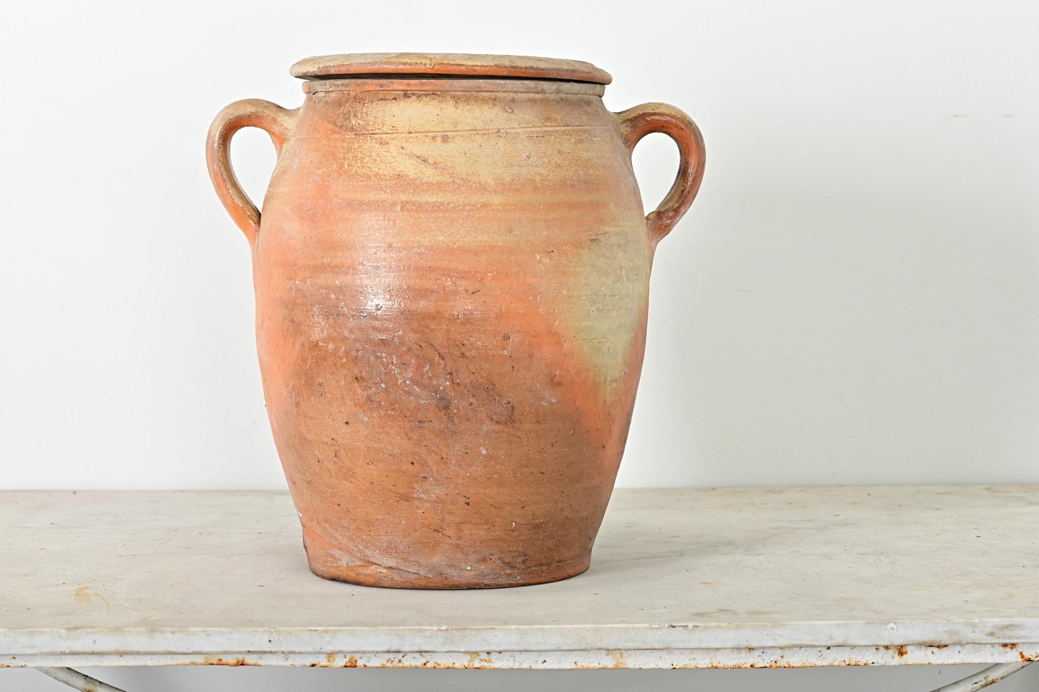 A French vintage glazed stoneware confit-type pot with lid and a pair of handles to help lift the substantial vessel. This utilitarian Provincial jar would have been used to store and preserve foods (like a confit or rillette) as there is a small